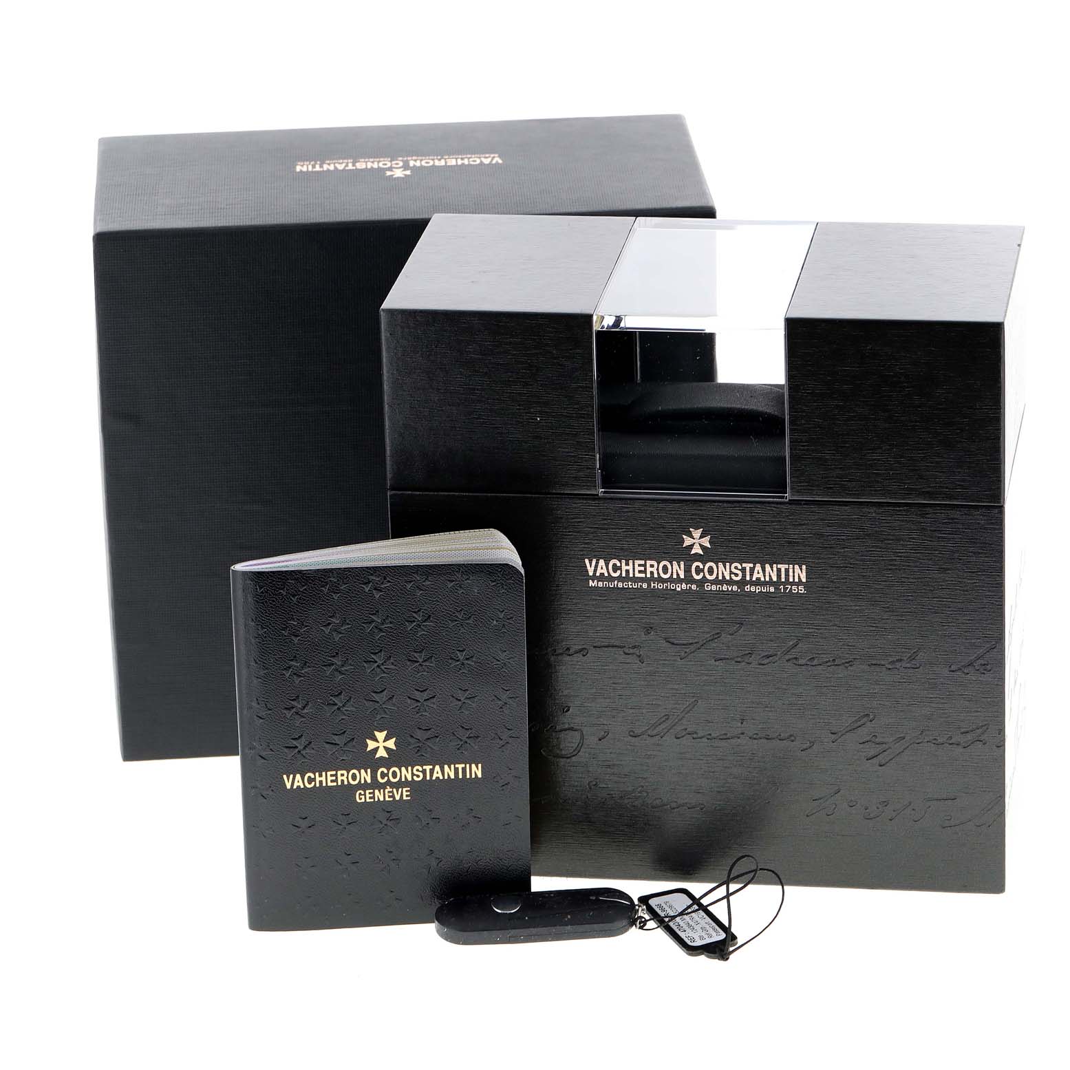 The image shows the packaging, a booklet, and tags for a Vacheron Constantin Overseas 47040/000R-9666 Men's Rose Gold Black Dial 47040/000R-9666 Men's Rose Gold Black Dial model watch.