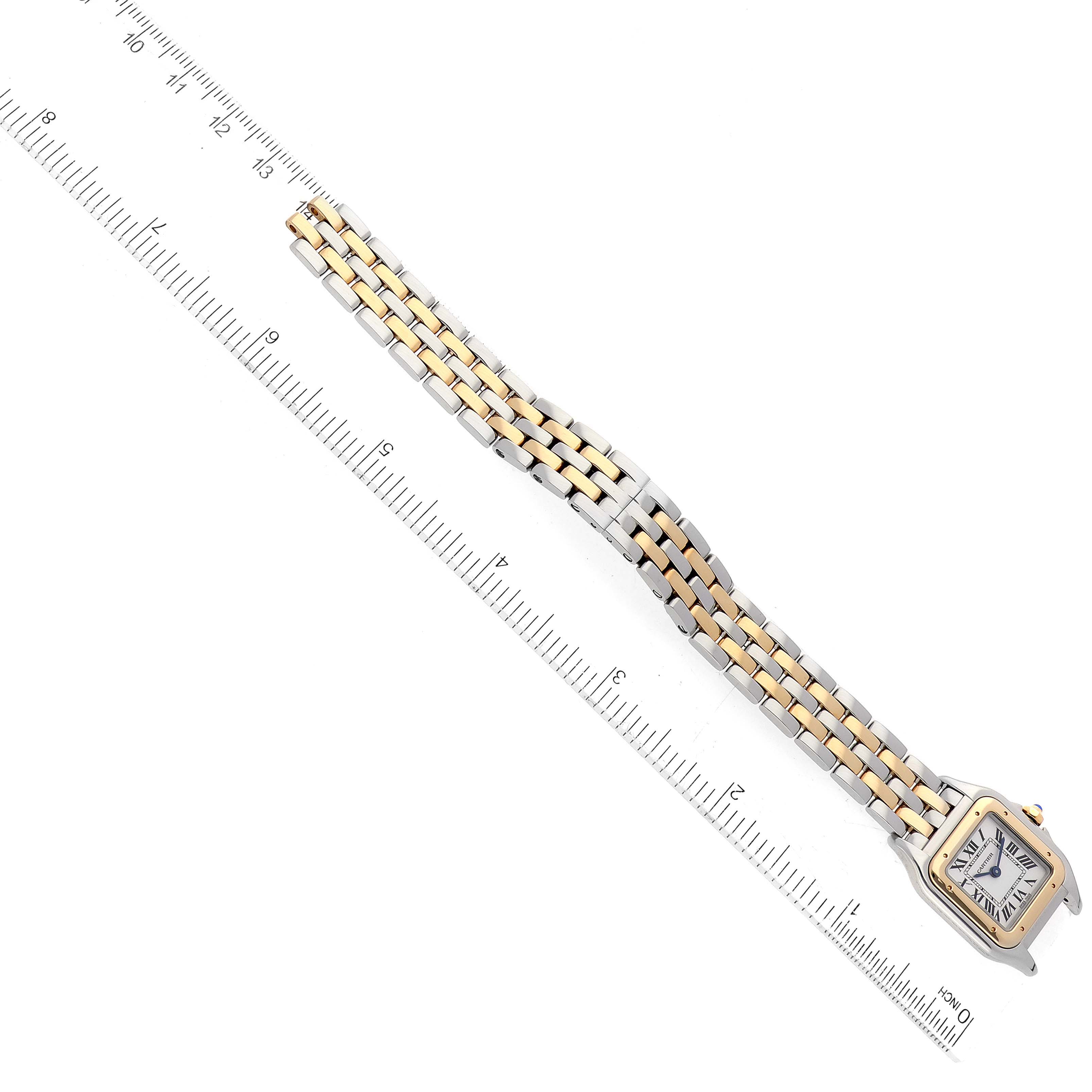 The image shows a top-down view of a Cartier Panthere W2PN0006 Women's Steel and Gold (two tone) Silver Dial W2PN0006 Women's Steel and Gold (two tone) Silver Dial watch, emphasizing its bicolor bracelet and square face with a ruler for scale.