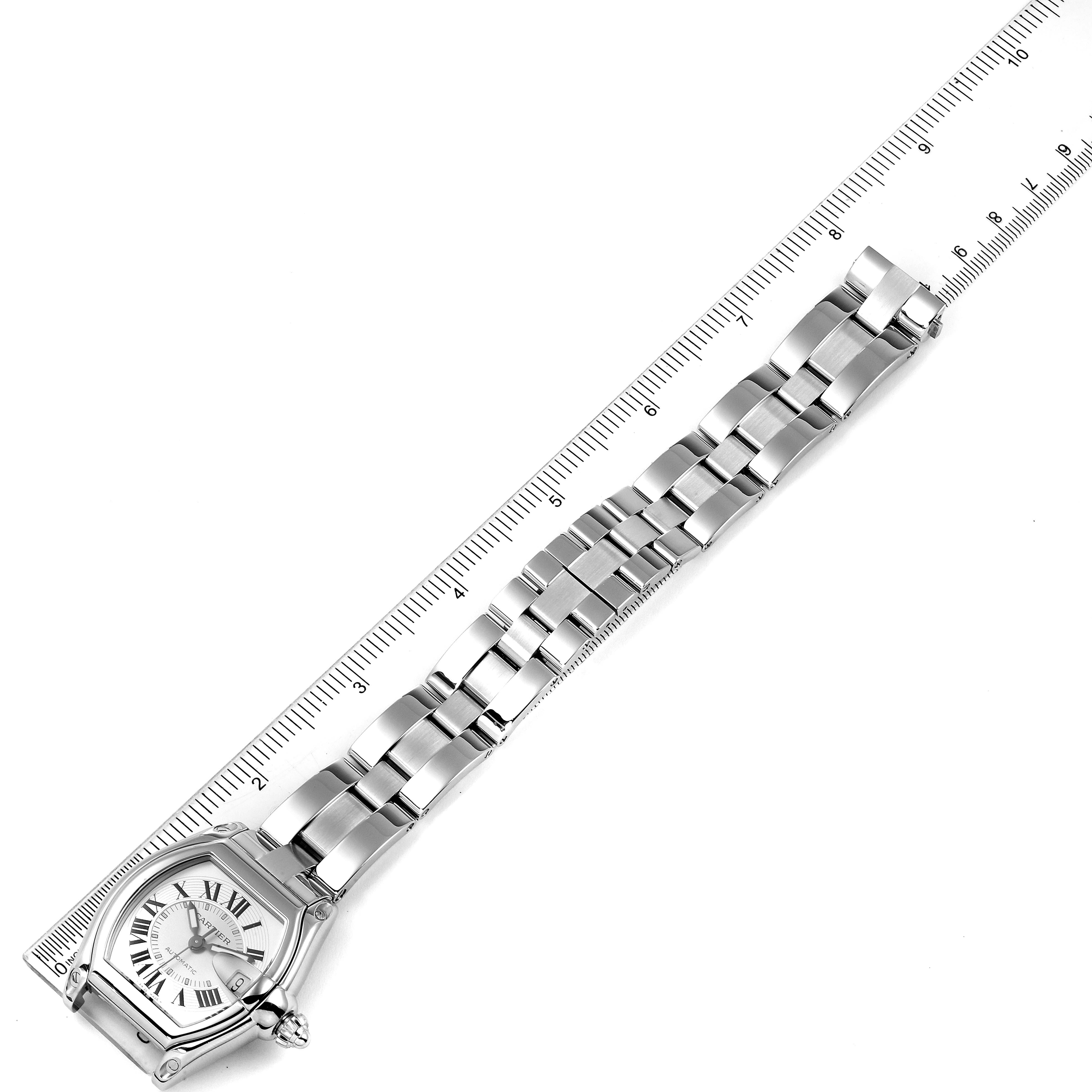 The Cartier Roadster W62000V3 Men's Stainless Steel Silver Dial W62000V3 Men's Stainless Steel Silver Dial watch is shown from above, displaying the face and the entire metal bracelet with a ruler as a size reference.
