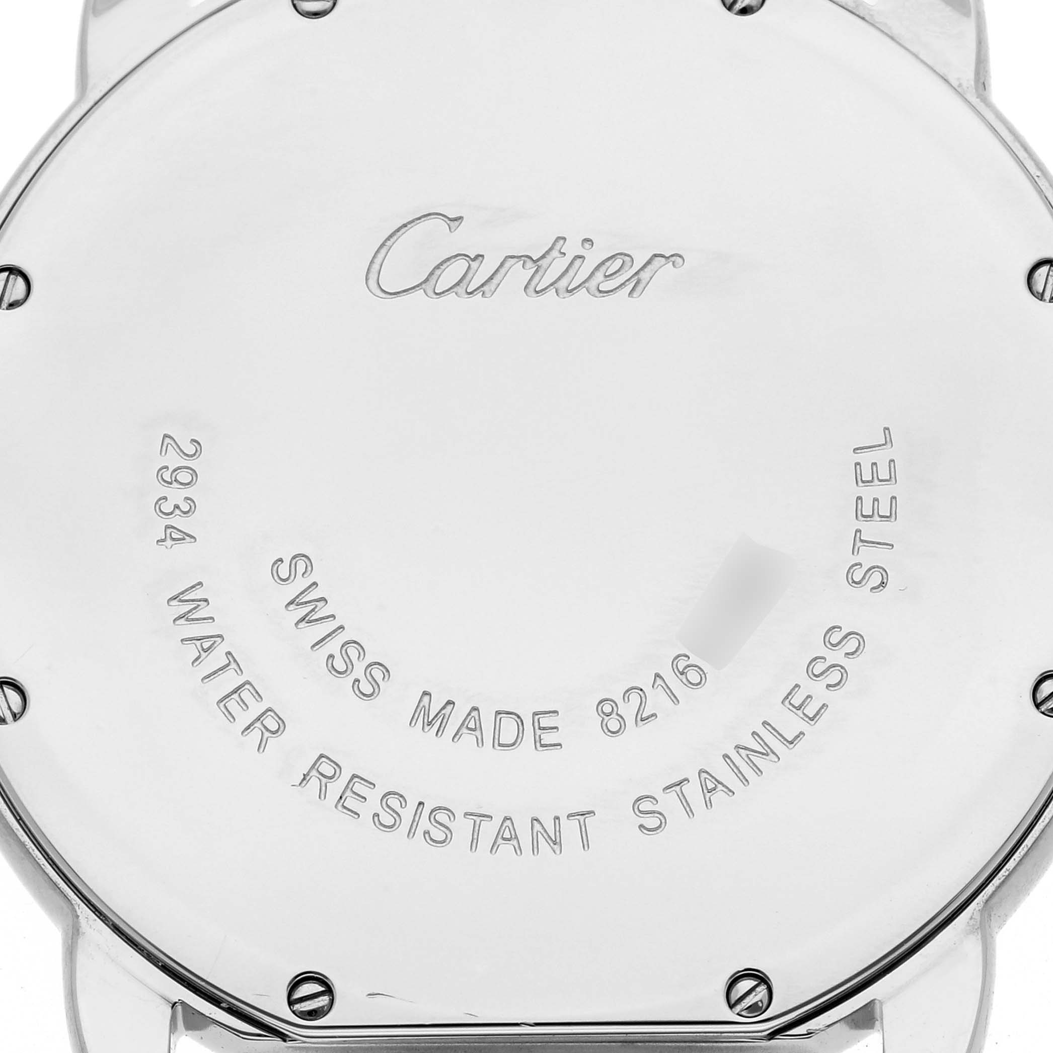 The image shows the back case of the Cartier Ronde WSRN0029 Women
s Stainless Steel Silver Dial WSRN0029 Women
s Stainless Steel Silver Dial watch, displaying inscriptions and screws.