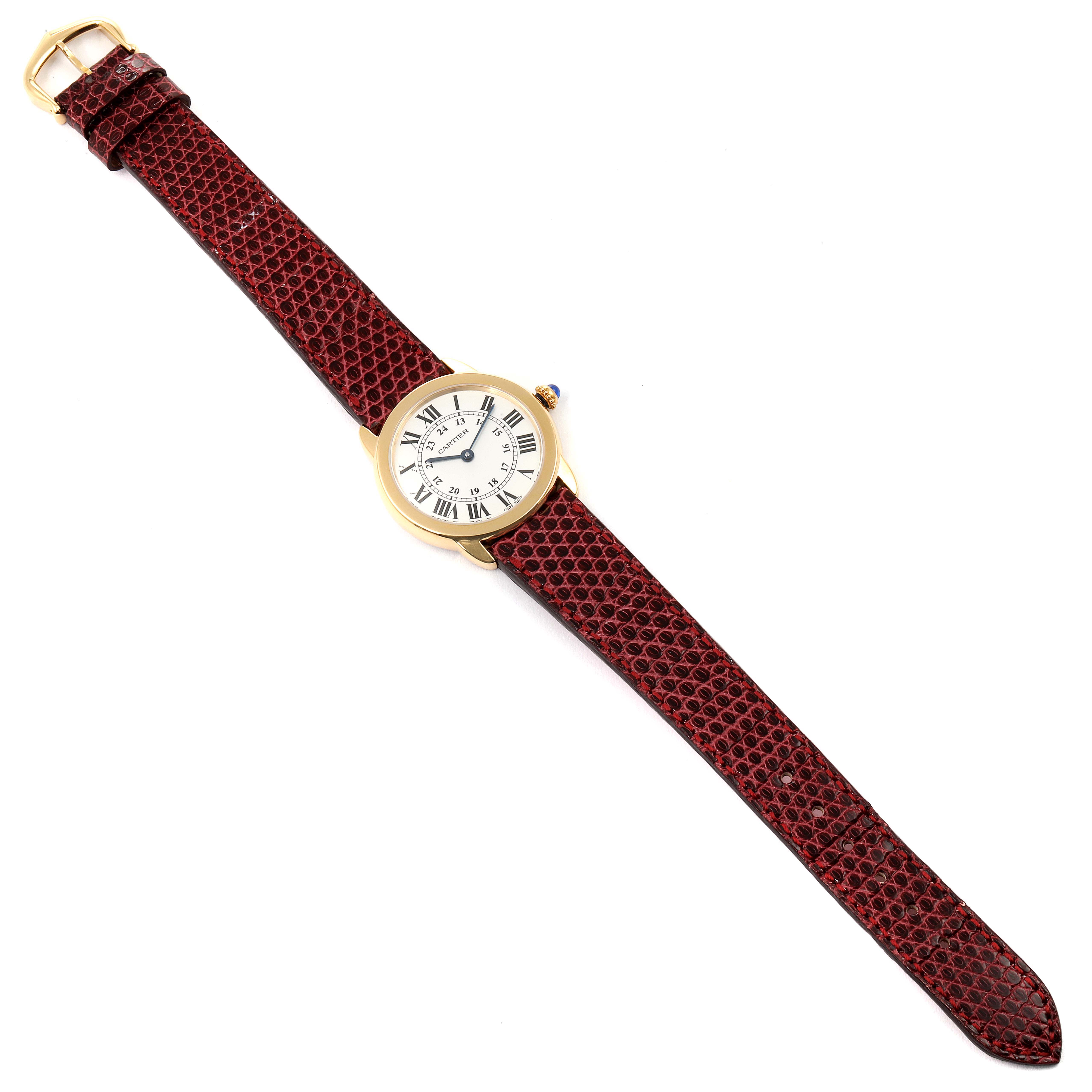 The image shows the entire Ronde model by Cartier from a top-down angle, including the watch face and the leather strap.