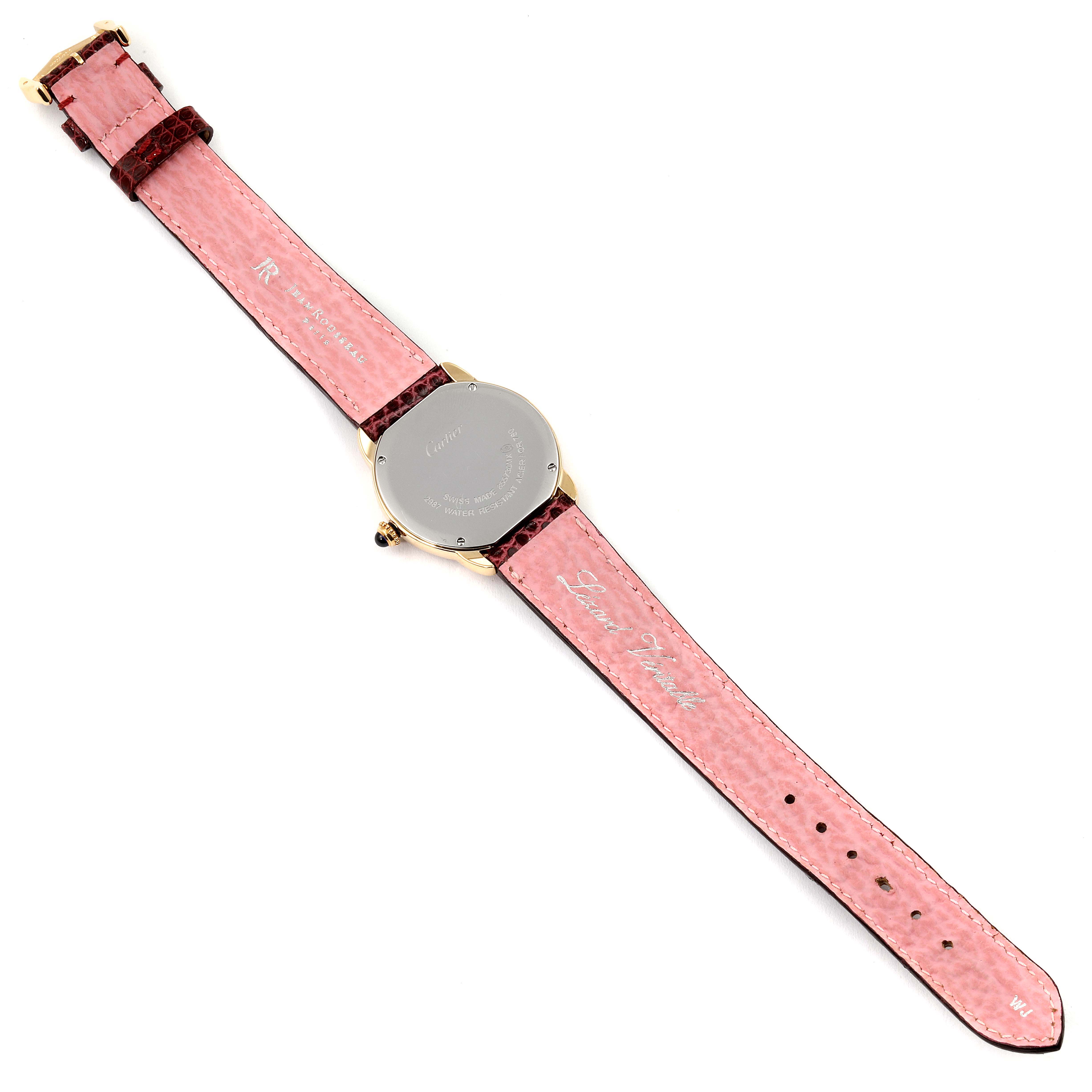 The image shows the back of a Cartier Ronde W6700355 Women's Yellow Gold Silver Dial W6700355 Women's Yellow Gold Silver Dial model watch with a pink strap and visible inscriptions.