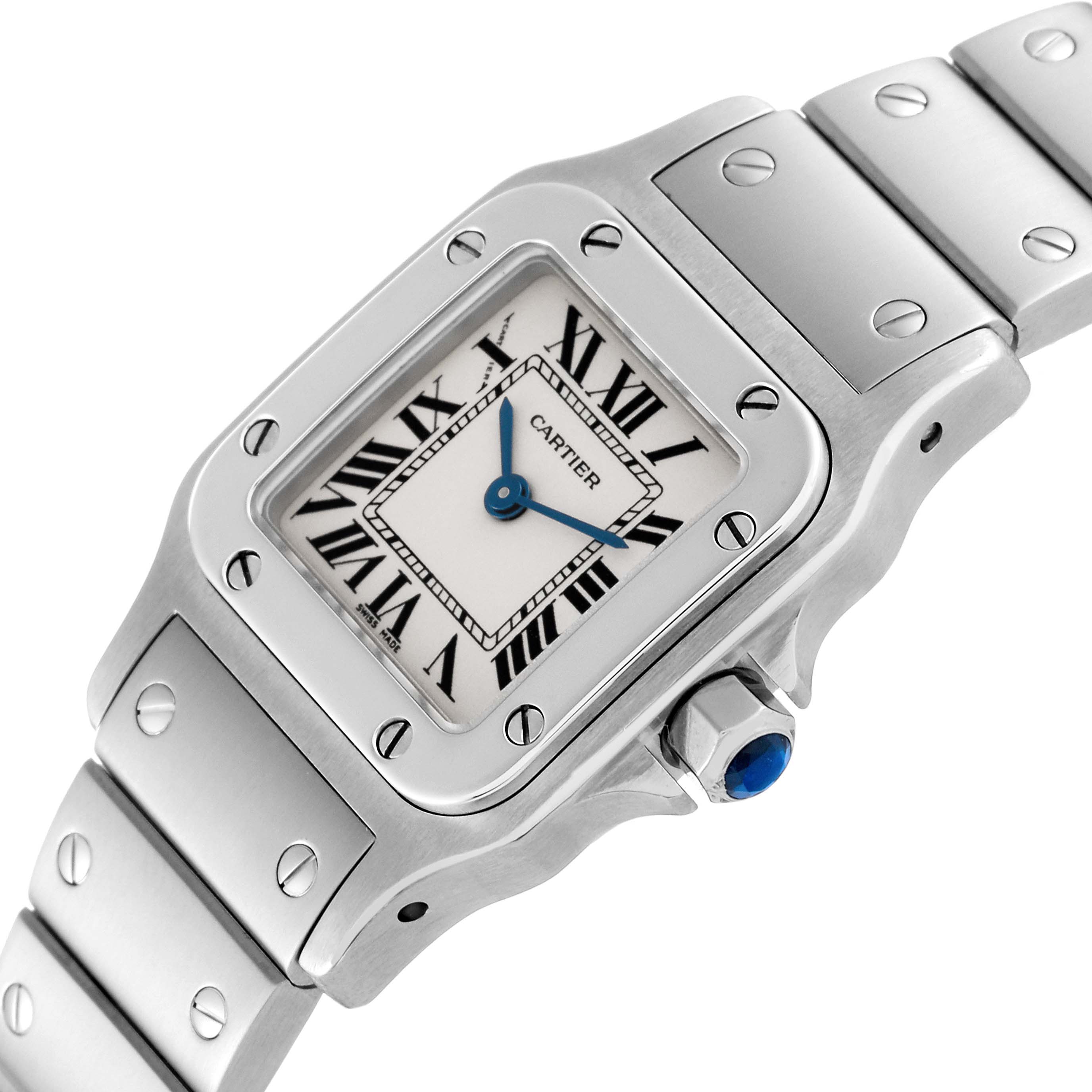 This image shows a close-up of the Santos de Cartier watch
s face and part of its metal bracelet from a slight angle.