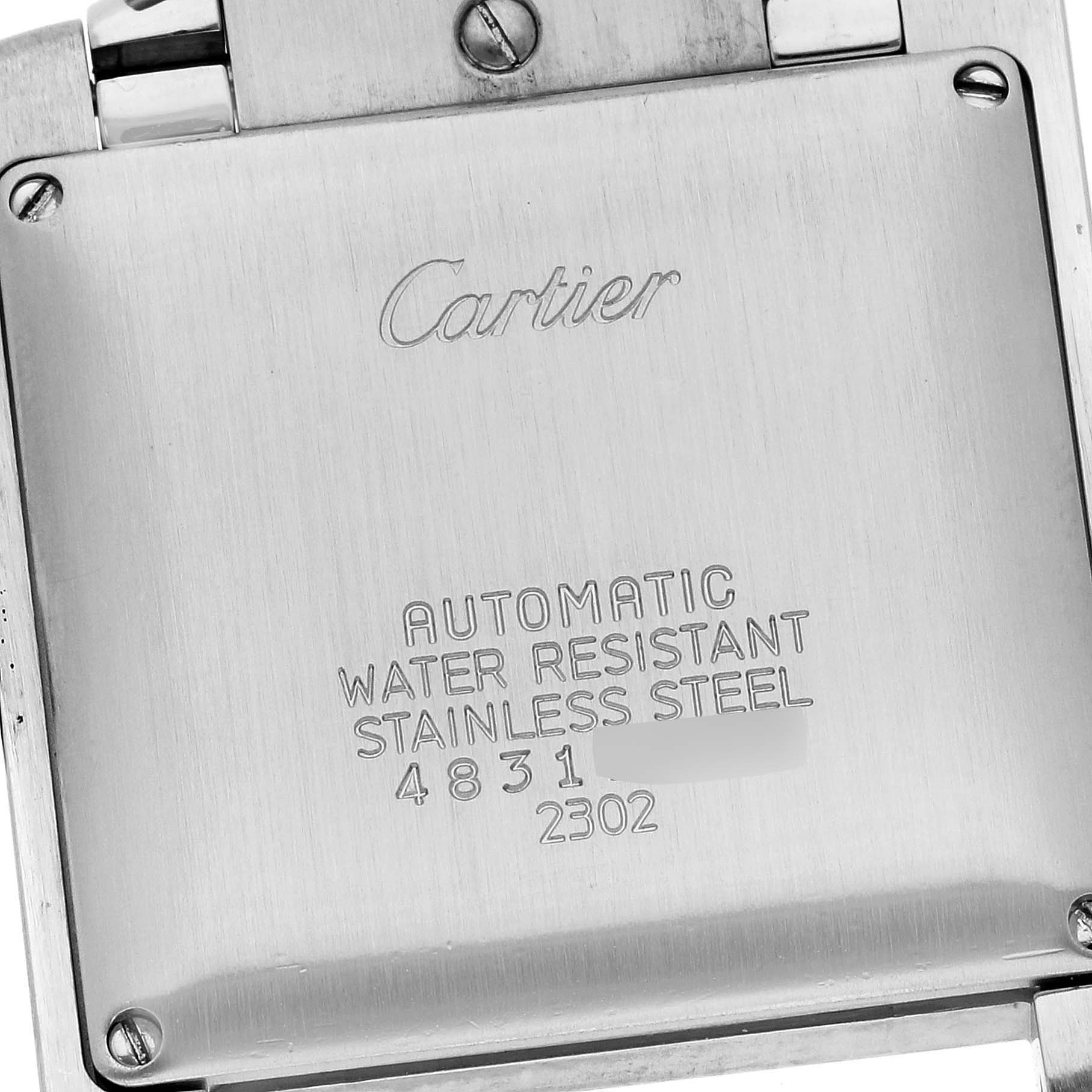This image shows the back case of a Cartier Tank Française watch, highlighting its engravings and metal surface.