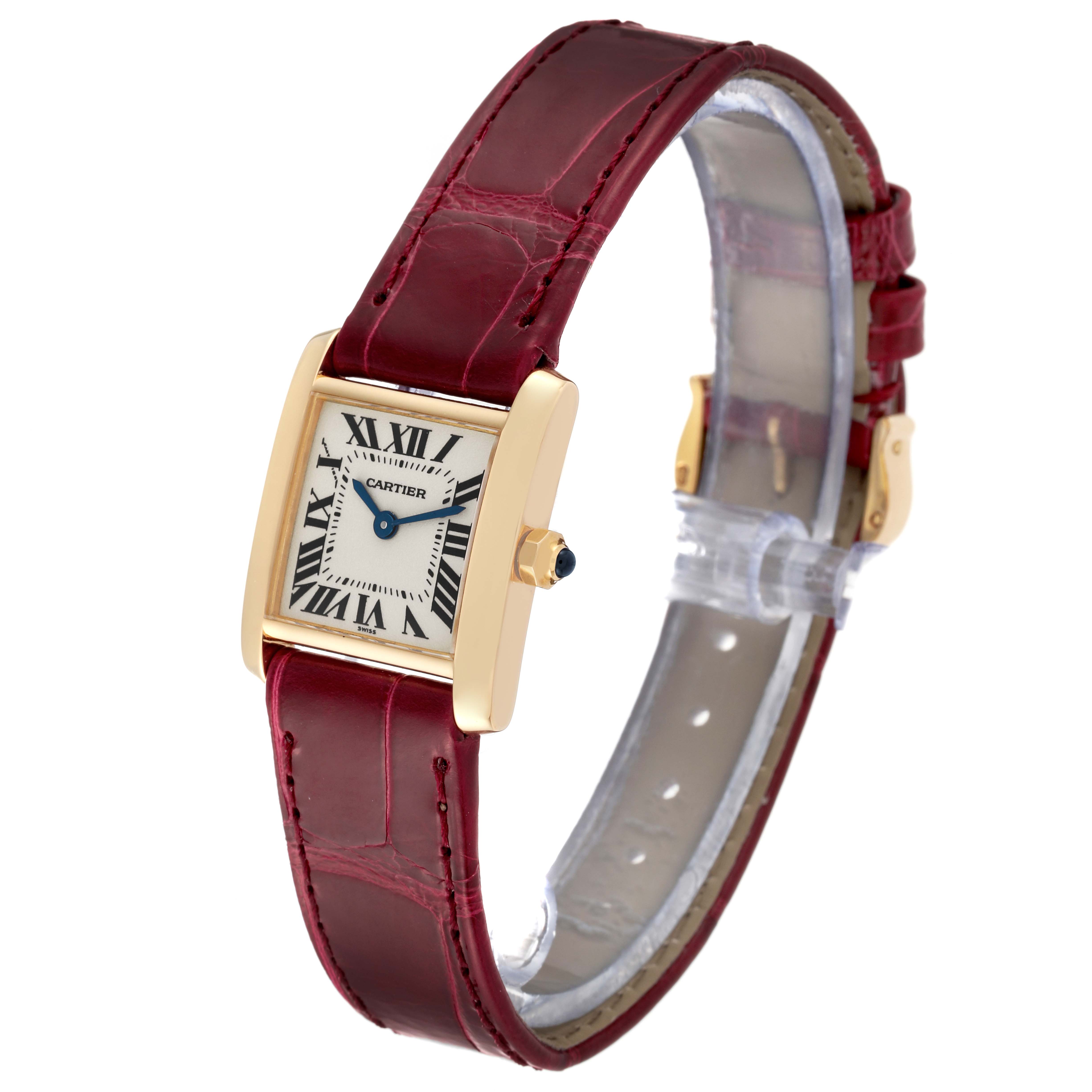 The image shows a Cartier Tank Française watch angled slightly to the side, displaying the dial and red leather strap.