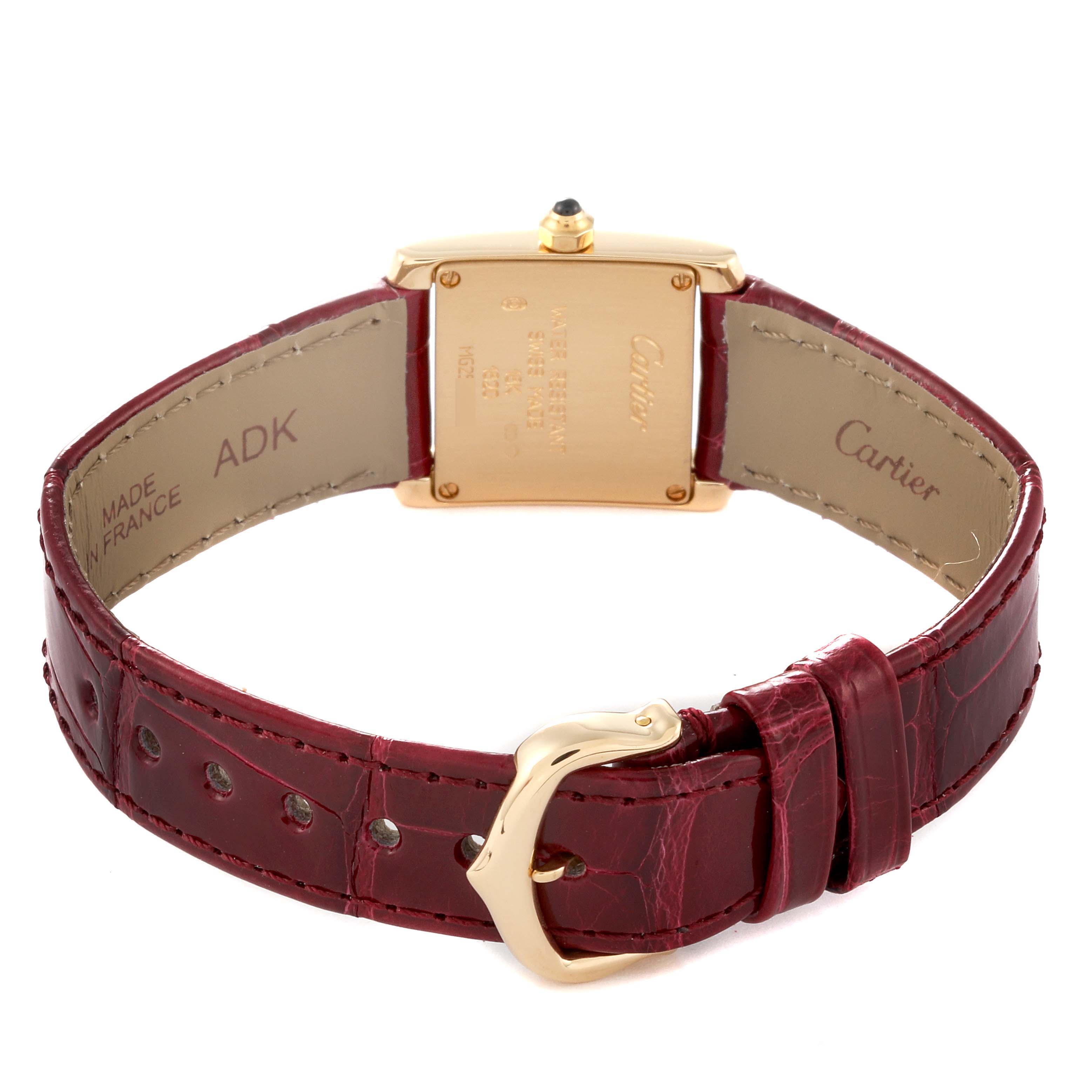The image shows the rear view of a Cartier Tank Francaise W5000256 Women's Yellow Gold Silver Dial W5000256 Women's Yellow Gold Silver Dial watch, including the case back and maroon leather strap with buckle.