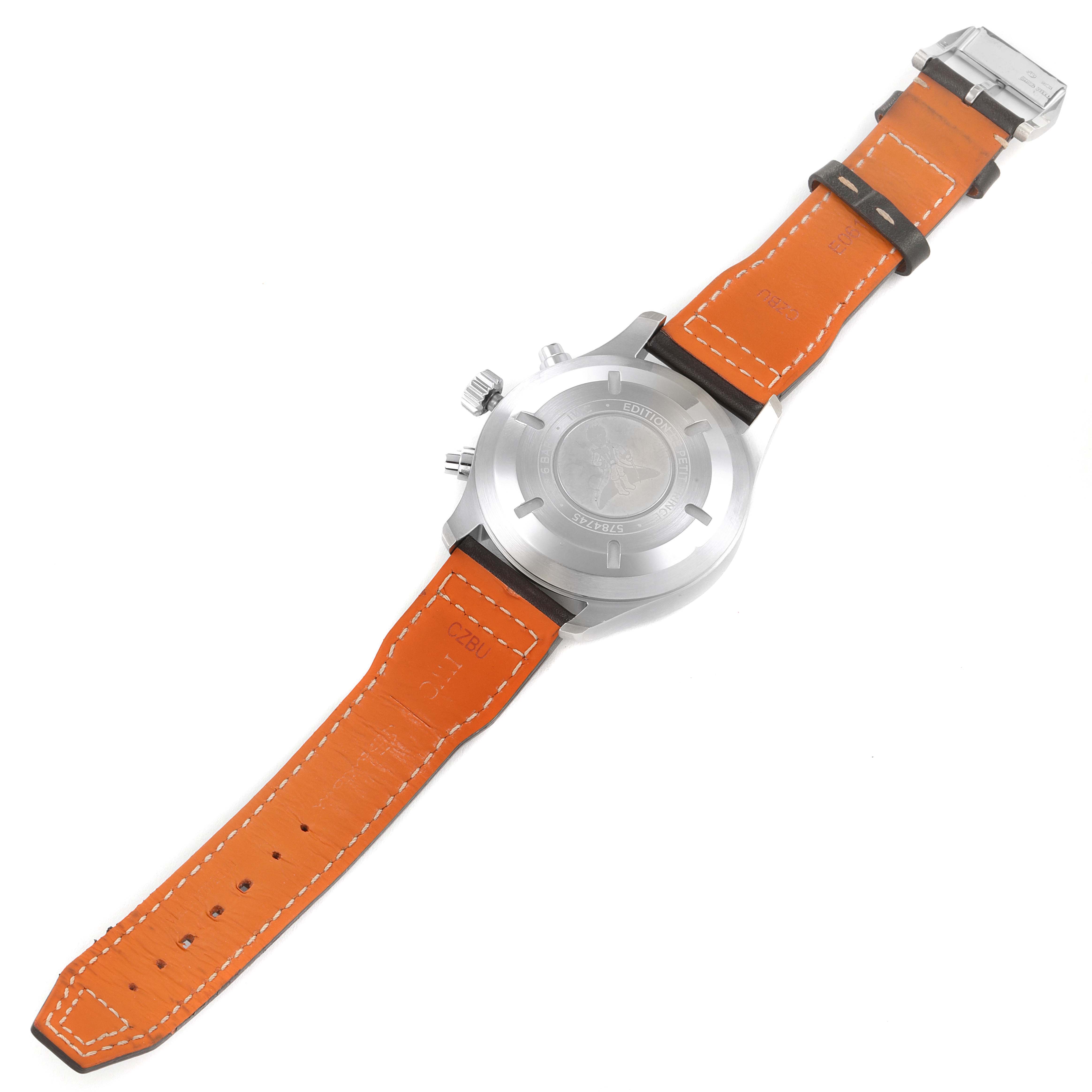The image shows the back view of a Pilot model watch by IWC, featuring an orange leather strap and stainless steel case.