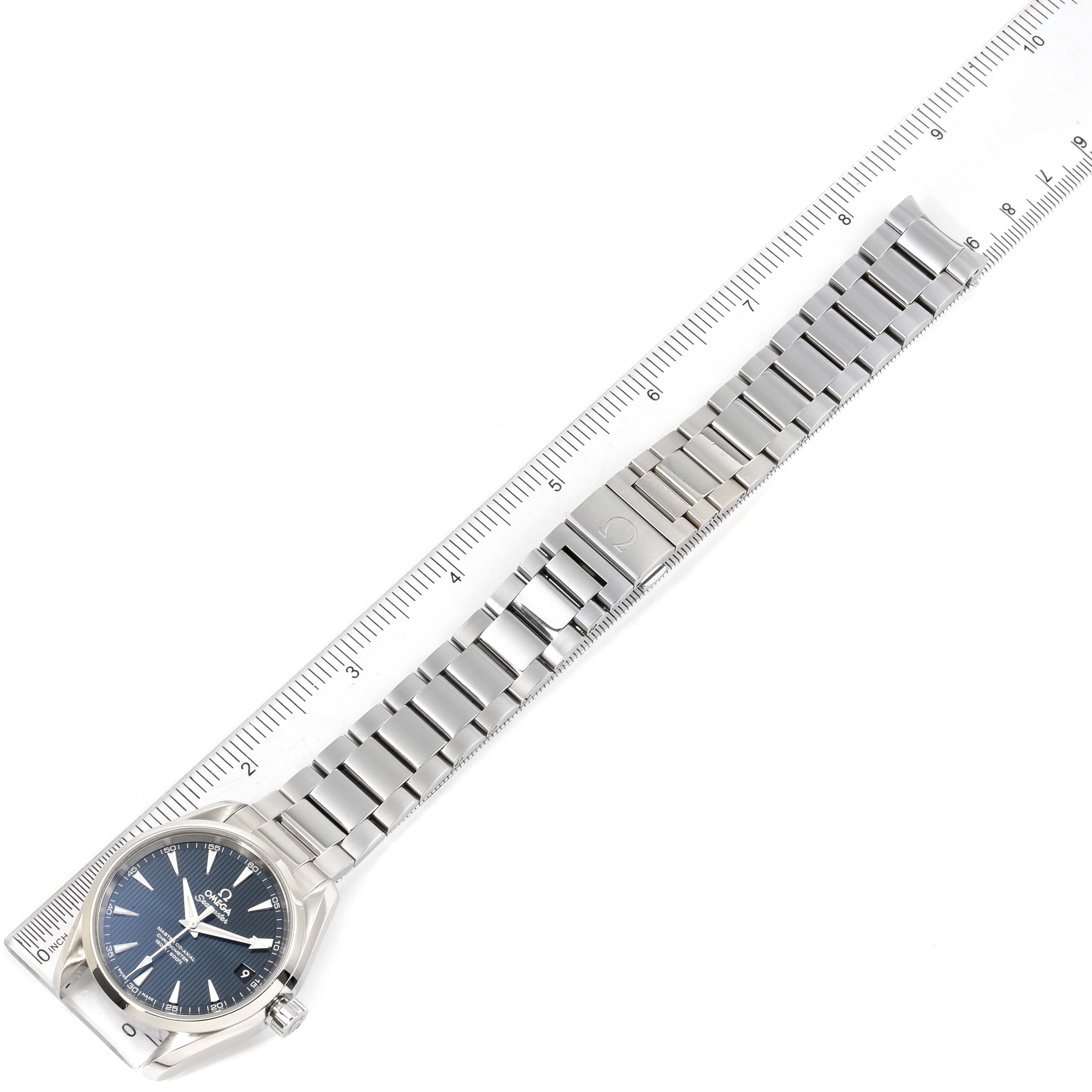 The image shows an Omega Aqua Terra 231.10.39.21.03.002 Men
s Stainless Steel Blue Dial 231.10.39.21.03.002 Men
s Stainless Steel Blue Dial watch and its metal bracelet laid out straight alongside a ruler.