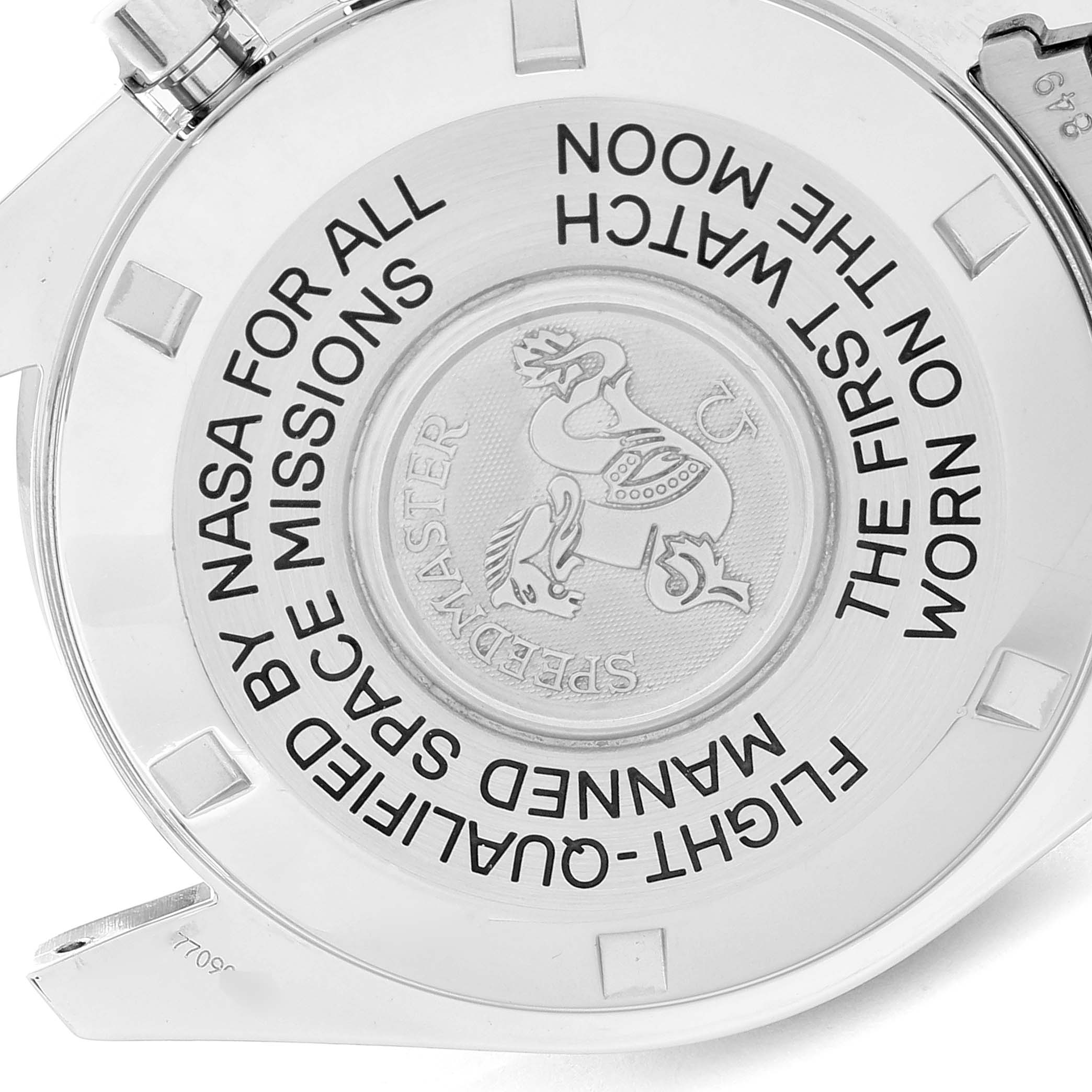The image shows the back case of an Omega Speedmaster 3575.20.00 Men's Stainless Steel White Dial 3575.20.00 Men's Stainless Steel White Dial watch, featuring its engraved logo and inscriptions about NASA's flight qualifications.