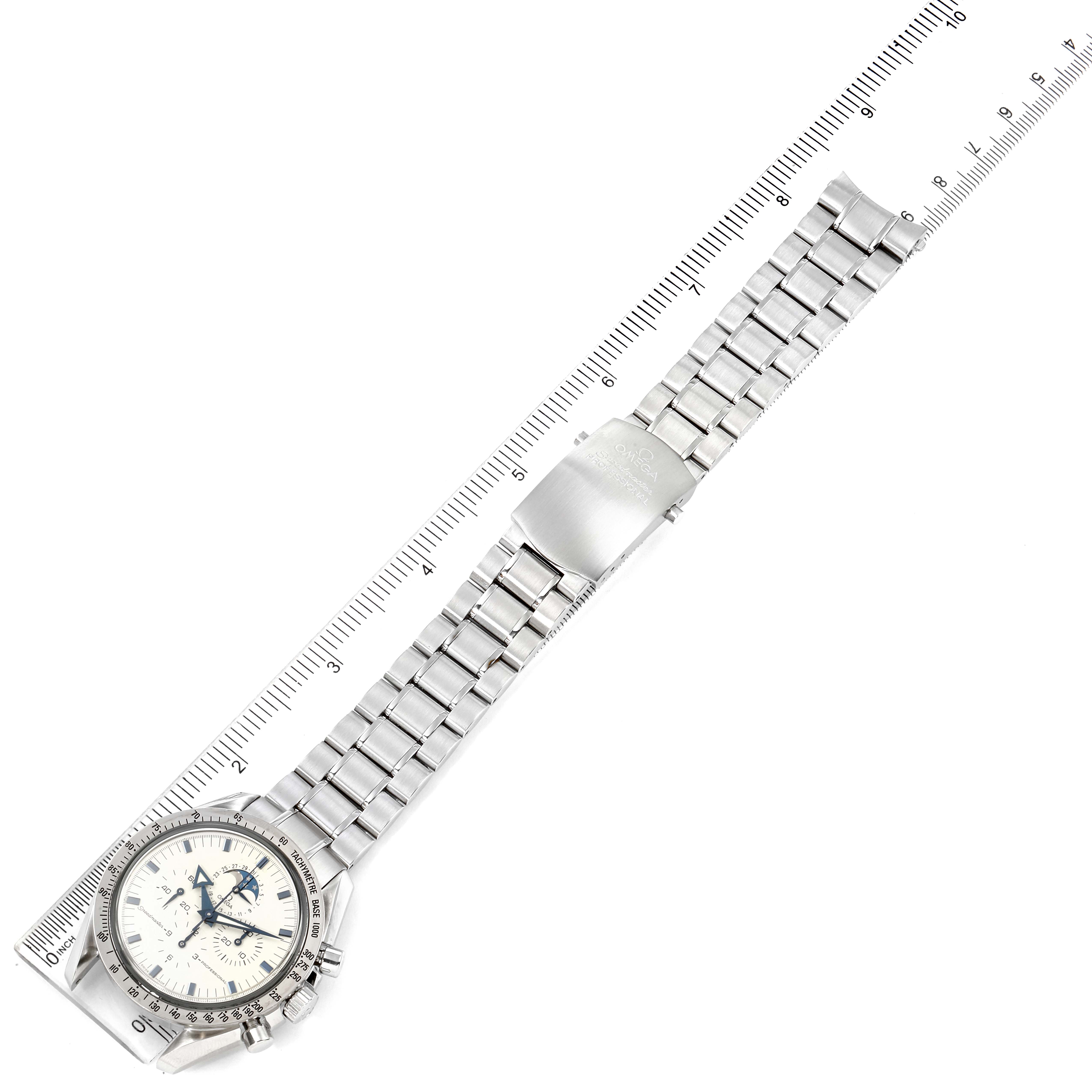 The image shows an Omega Speedmaster 3575.20.00 Men's Stainless Steel White Dial 3575.20.00 Men's Stainless Steel White Dial watch laid flat with a ruler for scale, displaying its face, bracelet, and clasp.