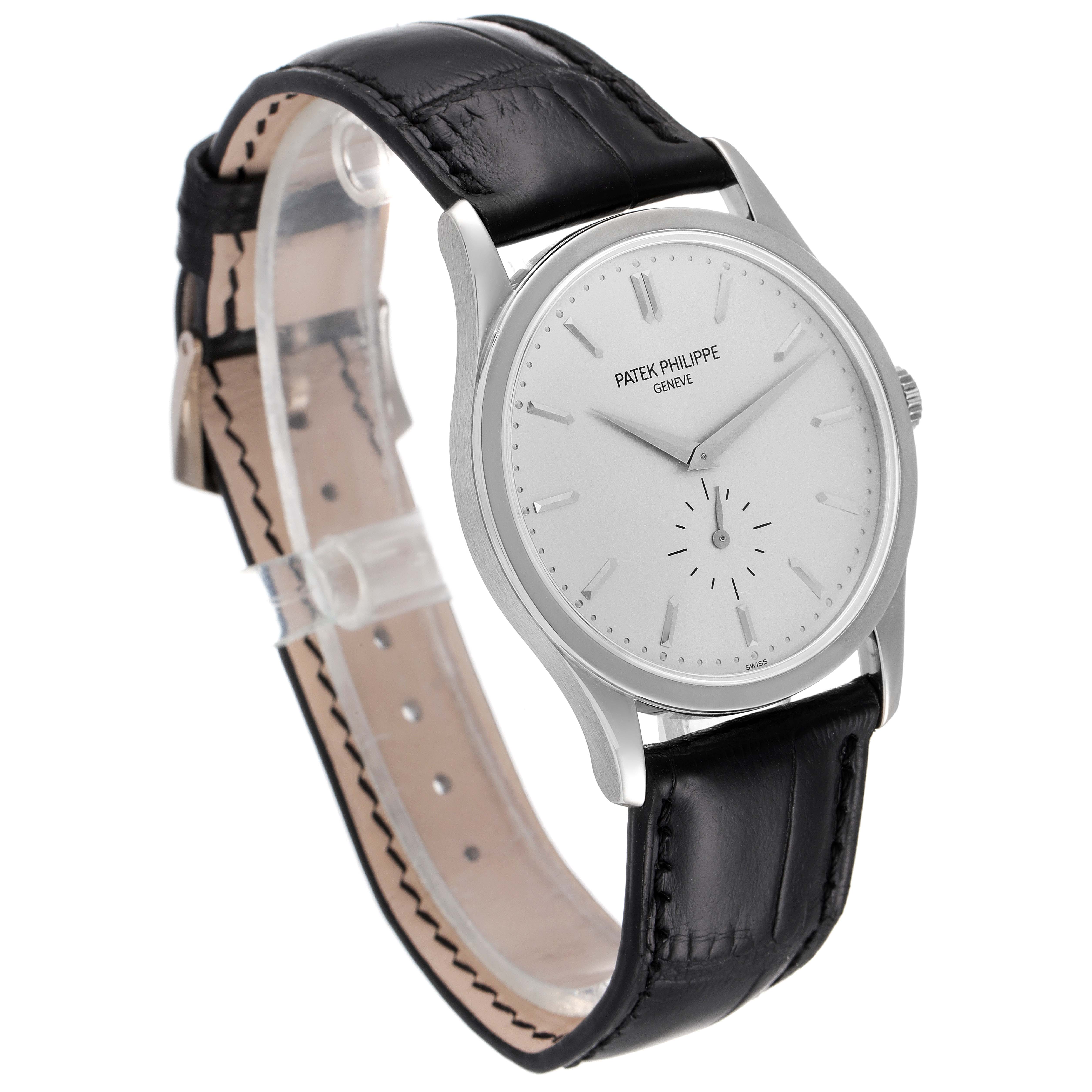 The image shows a Patek Philippe Calatrava 5196G Men's White Gold Silver Dial 5196G Men's White Gold Silver Dial watch from a front-left angle, highlighting its dial, case, and black leather strap.