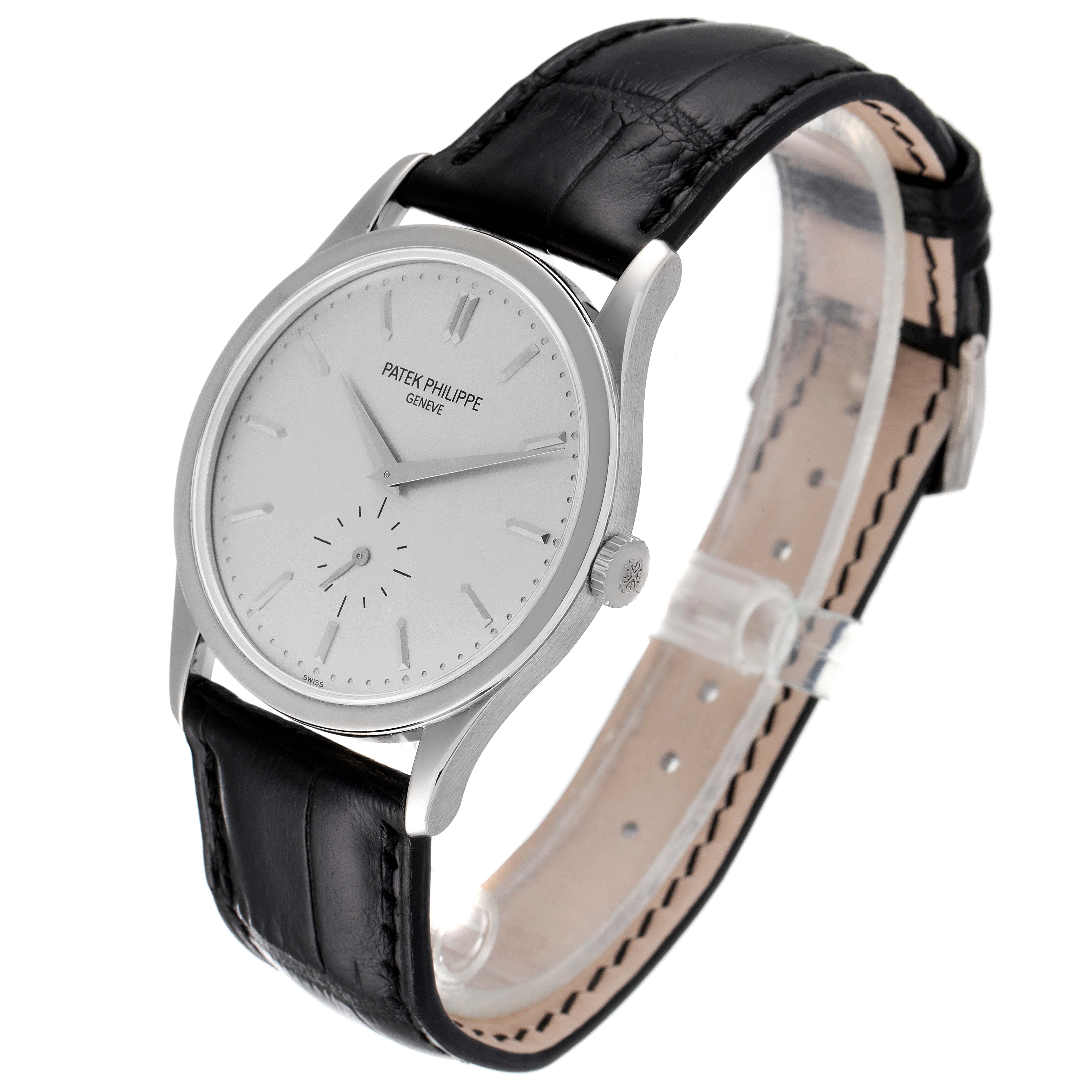 The image shows a Patek Philippe Calatrava 5196G Men's White Gold Silver Dial 5196G Men's White Gold Silver Dial watch at a three-quarter angle, displaying the face, hands, and black leather strap.