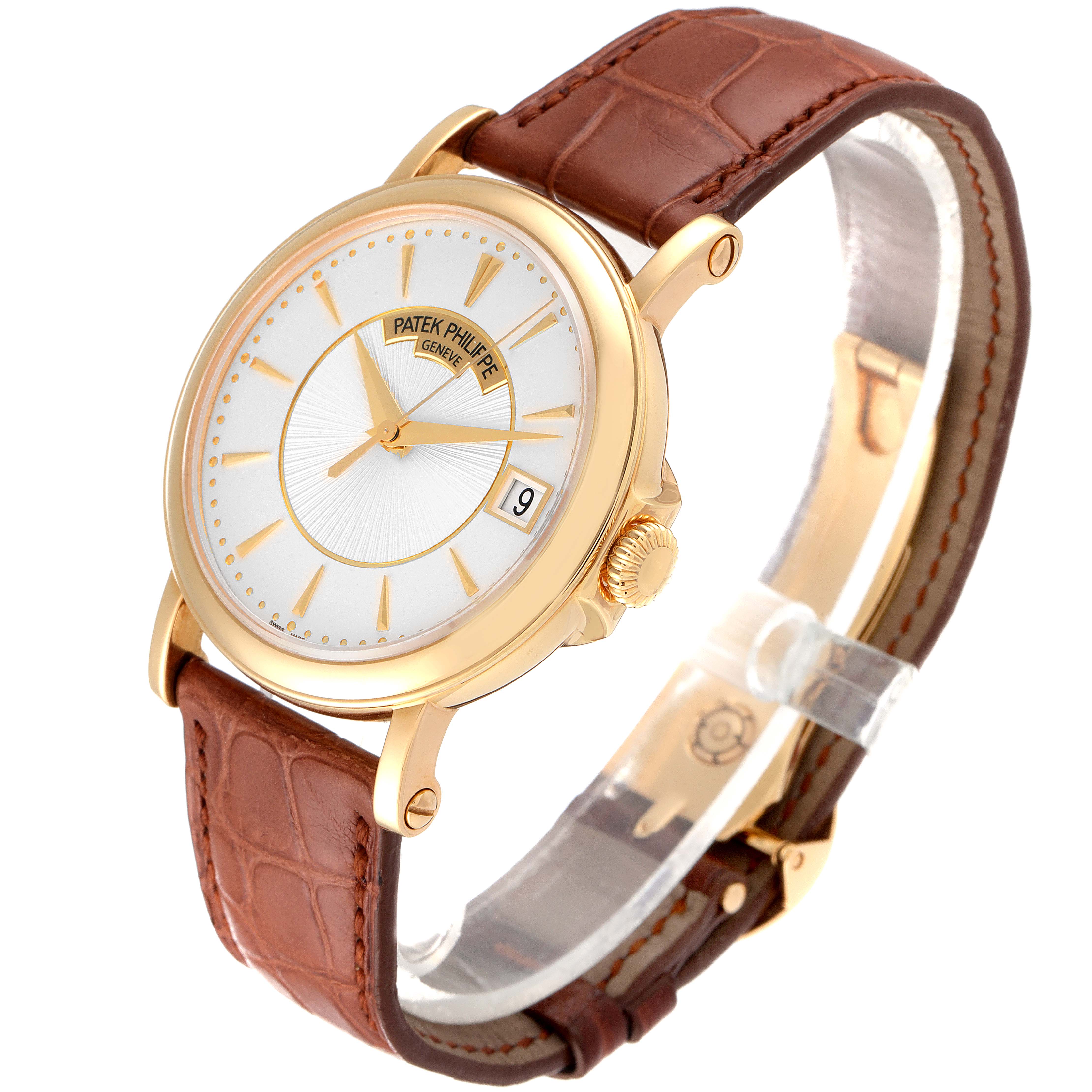 The image shows a Patek Philippe Calatrava 5153J Men's Yellow Gold Silver Dial 5153J Men's Yellow Gold Silver Dial watch at an angled view, highlighting its gold case, white dial, brown leather strap, and date window.