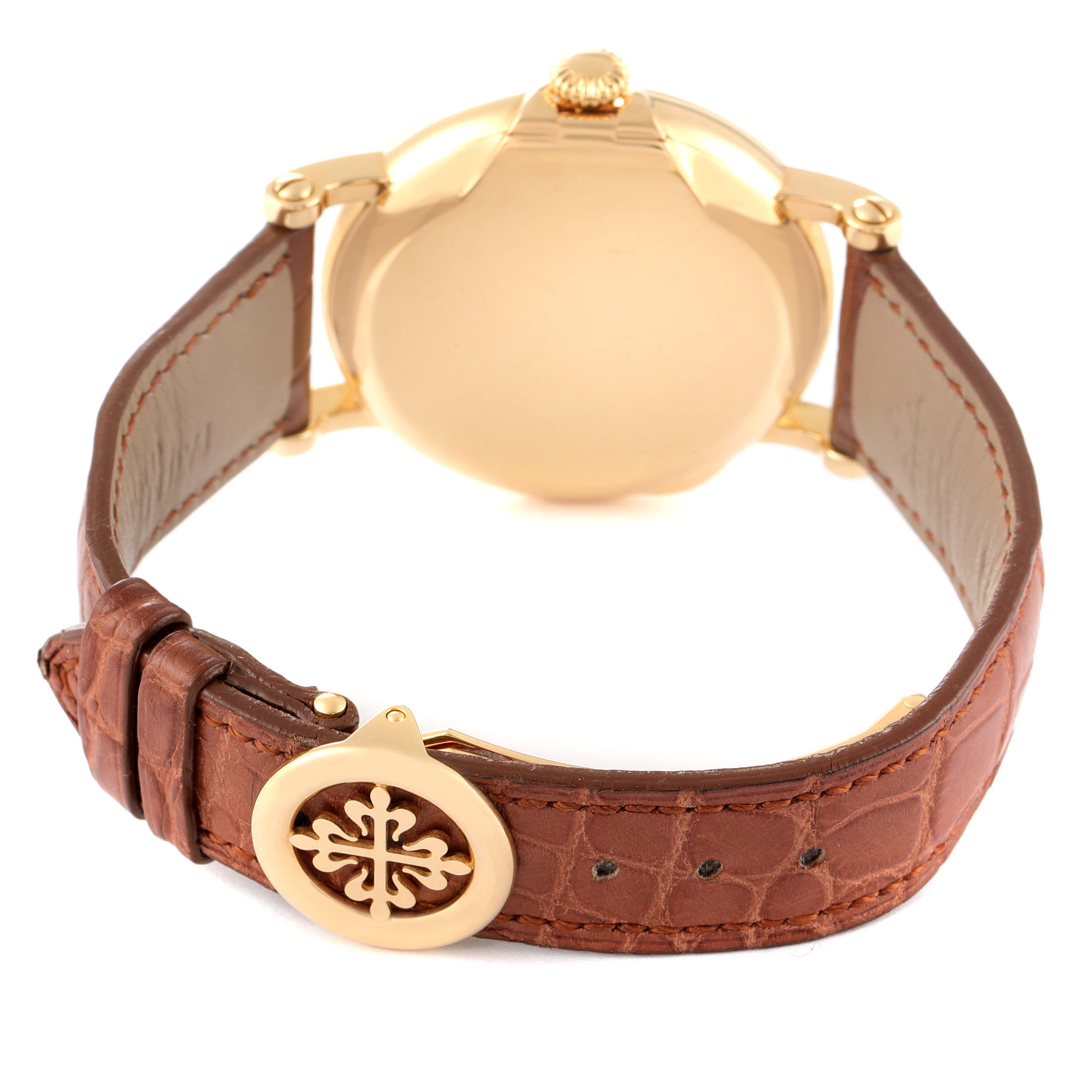 The image shows the back and clasp of a Patek Philippe Calatrava 5153J Men's Yellow Gold Silver Dial 5153J Men's Yellow Gold Silver Dial watch with a brown leather strap.