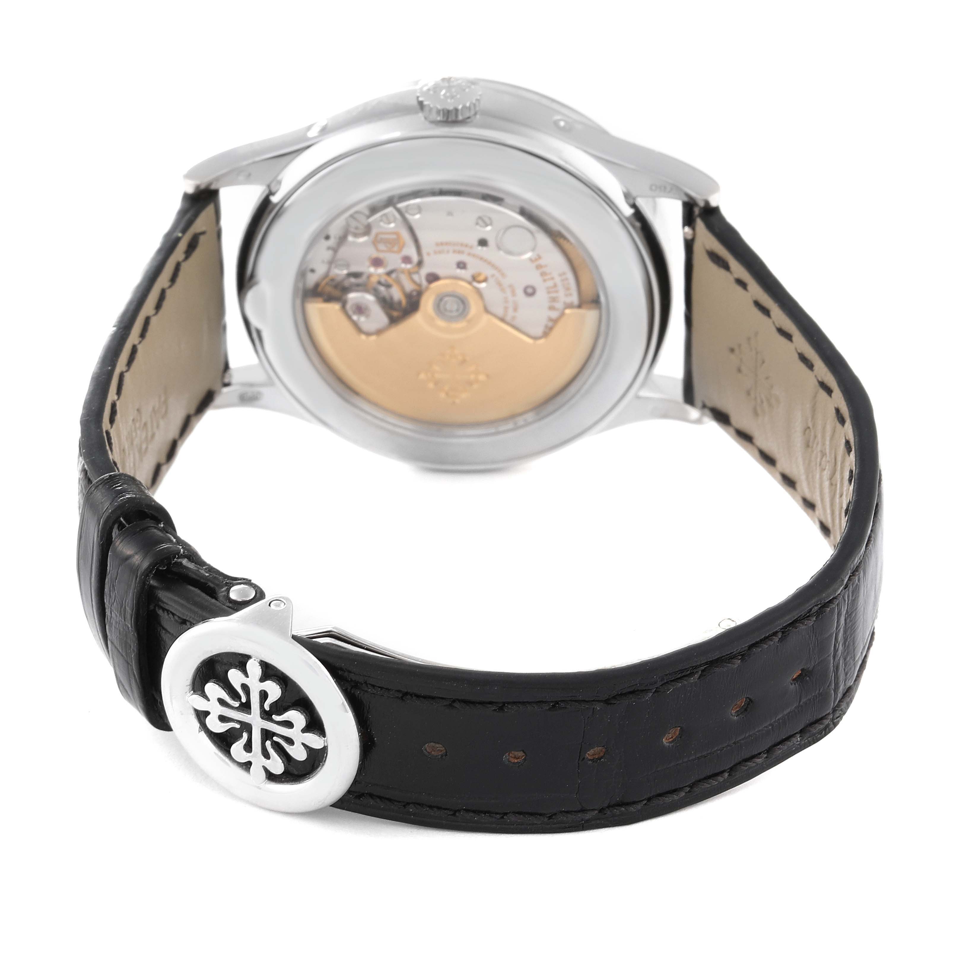 This image shows the back and movement mechanism of a Patek Philippe Complications 5396G-011 Men's White Gold Silver Dial 5396G-011 Men's White Gold Silver Dial watch, along with its leather strap and clasp.