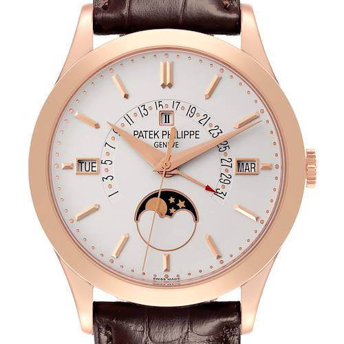 The Patek Philippe Complications watch is shown from a front angle, highlighting its dial, rose gold case, and leather strap.