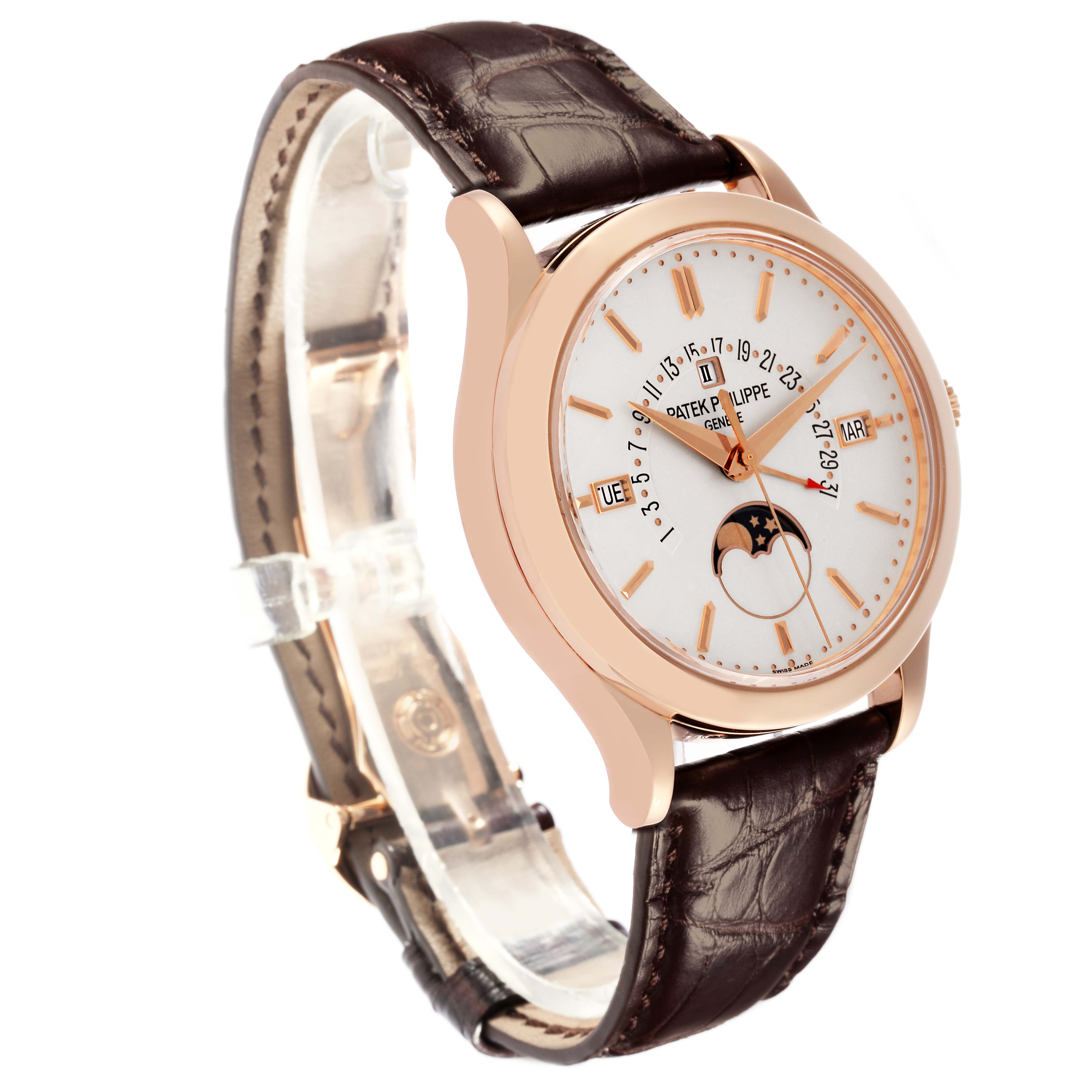 The Patek Philippe Complications 5496R-001 Men
s Rose Gold Silver Dial 5496R-001 Men
s Rose Gold Silver Dial watch is shown at a three-quarter angle, featuring the dial, case, and leather strap.