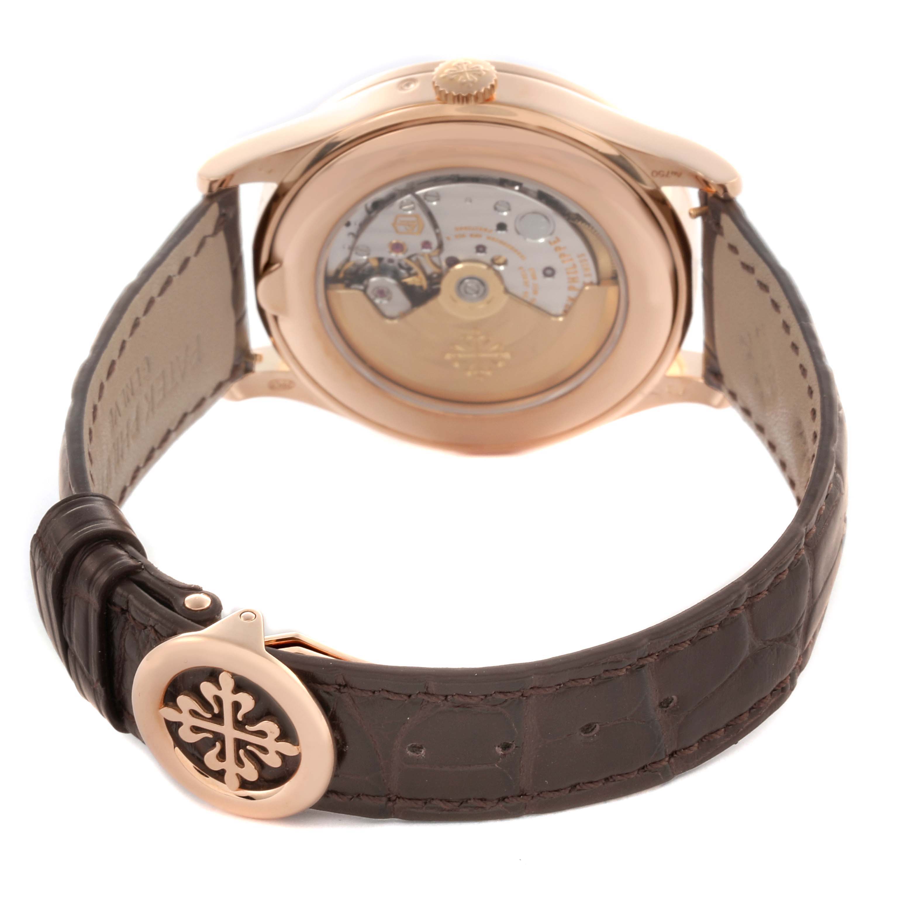The image shows the back view of a Patek Philippe Complications 5496R-001 Men
s Rose Gold Silver Dial 5496R-001 Men
s Rose Gold Silver Dial watch featuring the movement and leather strap clasp.