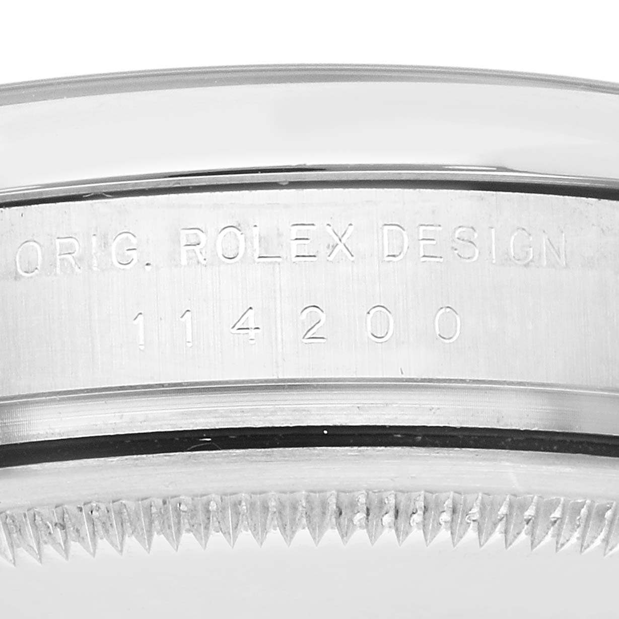 The image shows a close-up of the edge of the Rolex Air-King 114200 Men's Stainless Steel Silver Dial 114200 Men's Stainless Steel Silver Dial 114200 watch case with its model number engraved.
