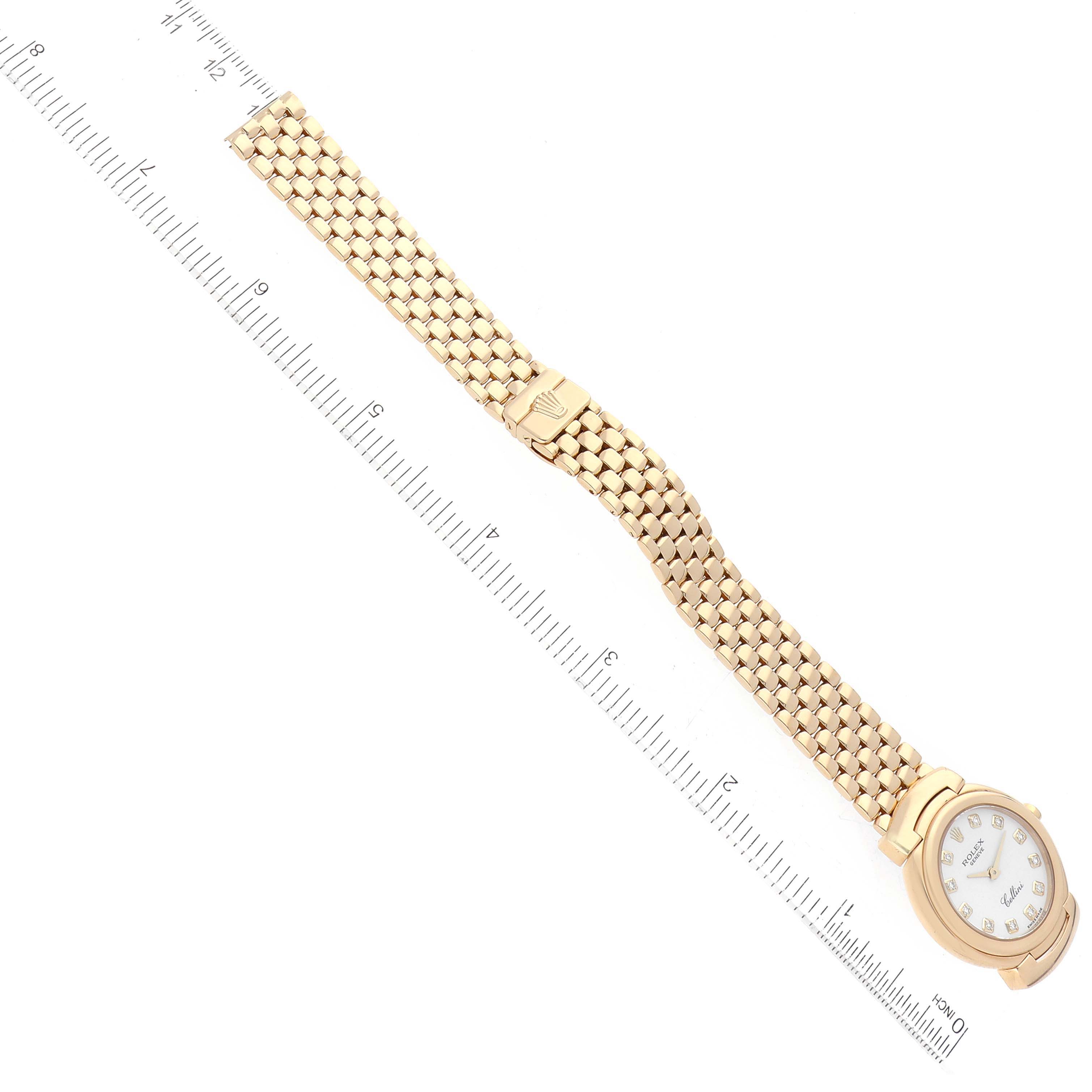 The image shows a top view of a Rolex Cellini 6621 Women's Yellow Gold White Dial 6621 Women's Yellow Gold White Dial watch, including its face, bezel, and bracelet, with a ruler for scale.