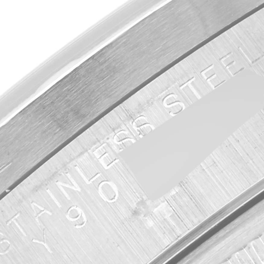 This close-up image shows the engraving inside the stainless steel case of a Rolex Date 15210 Men's Stainless Steel Black Dial 15210 Men's Stainless Steel Black Dial watch.