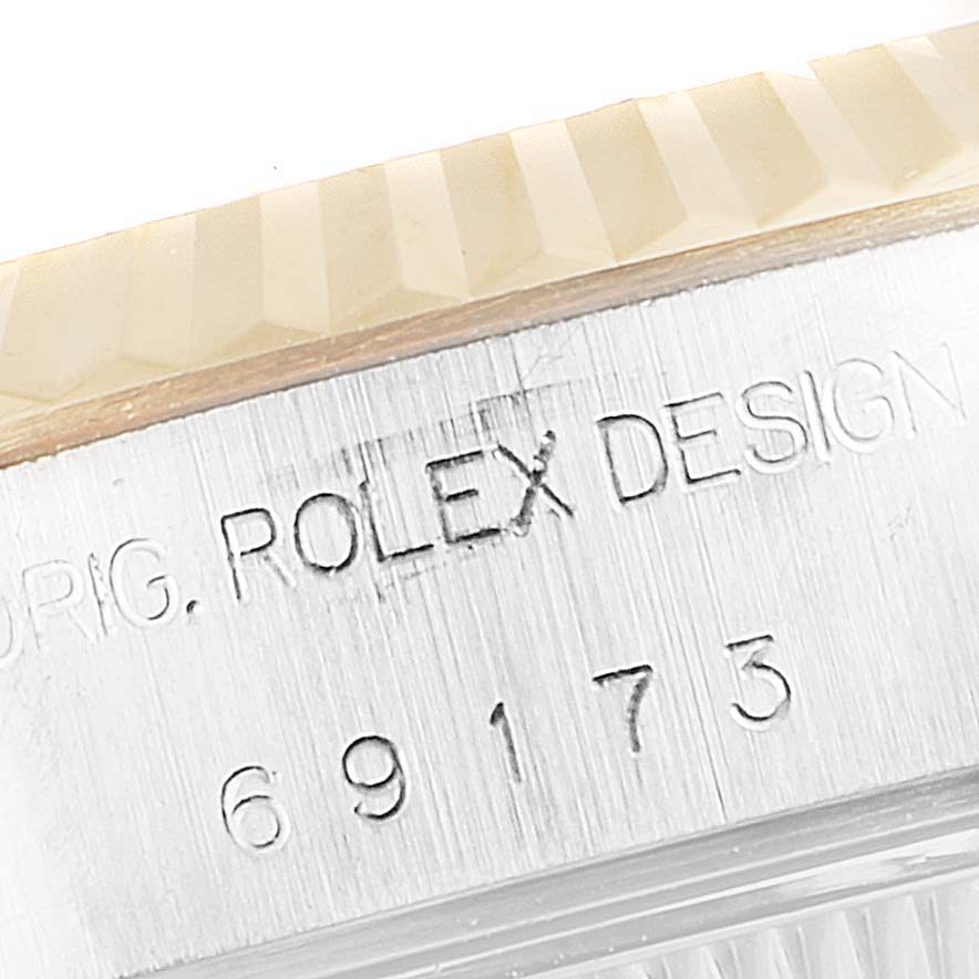 The image shows a close-up of the case side and fluted bezel on a Rolex Datejust 69173 Women's Steel and Gold (two tone) Blue Dial 69173 Women's Steel and Gold (two tone) Blue Dial watch, displaying the serial number and text.