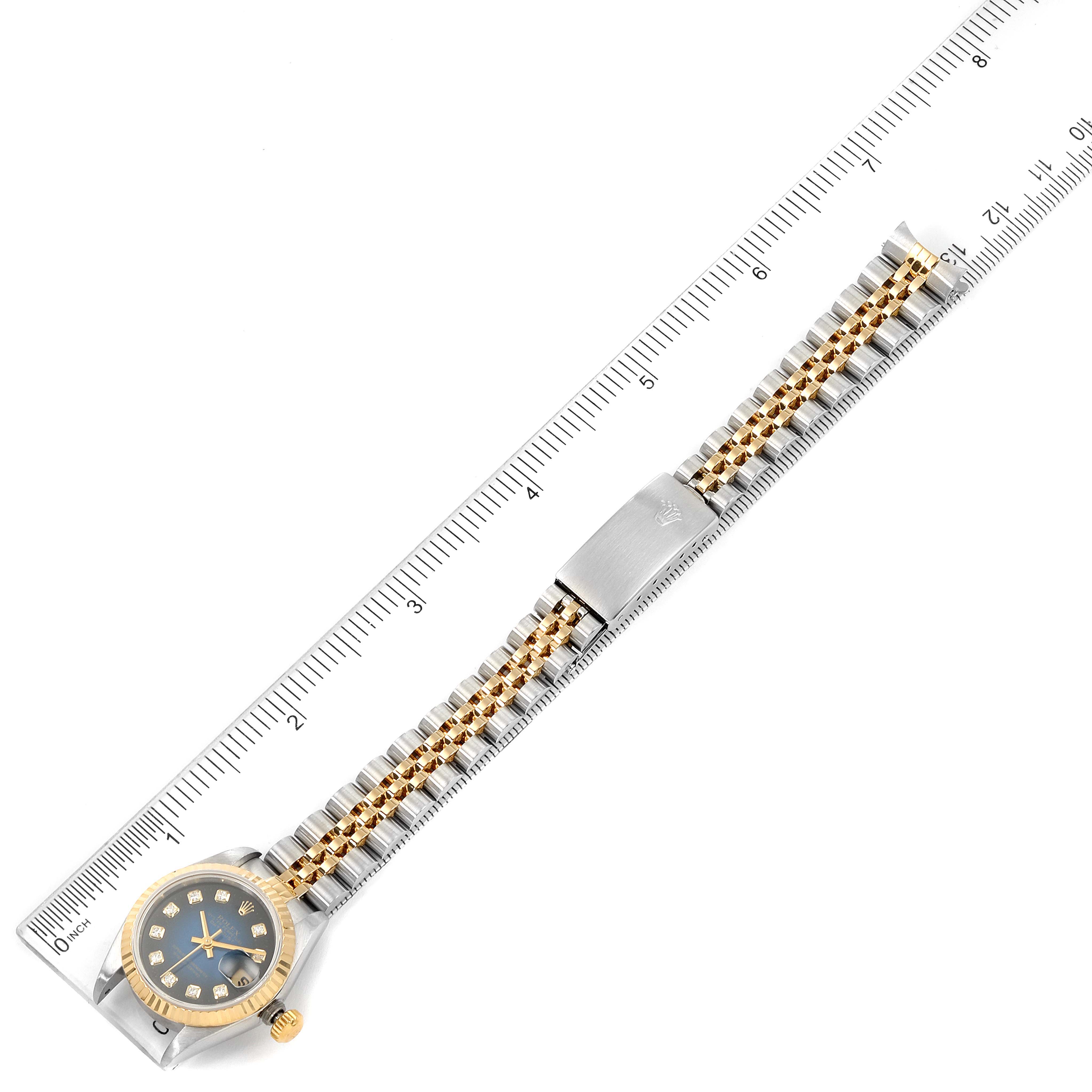 This image shows a Rolex Datejust 69173 Women's Steel and Gold (two tone) Blue Dial 69173 Women's Steel and Gold (two tone) Blue Dial watch laid flat alongside a ruler, displaying the entire watch band and face.