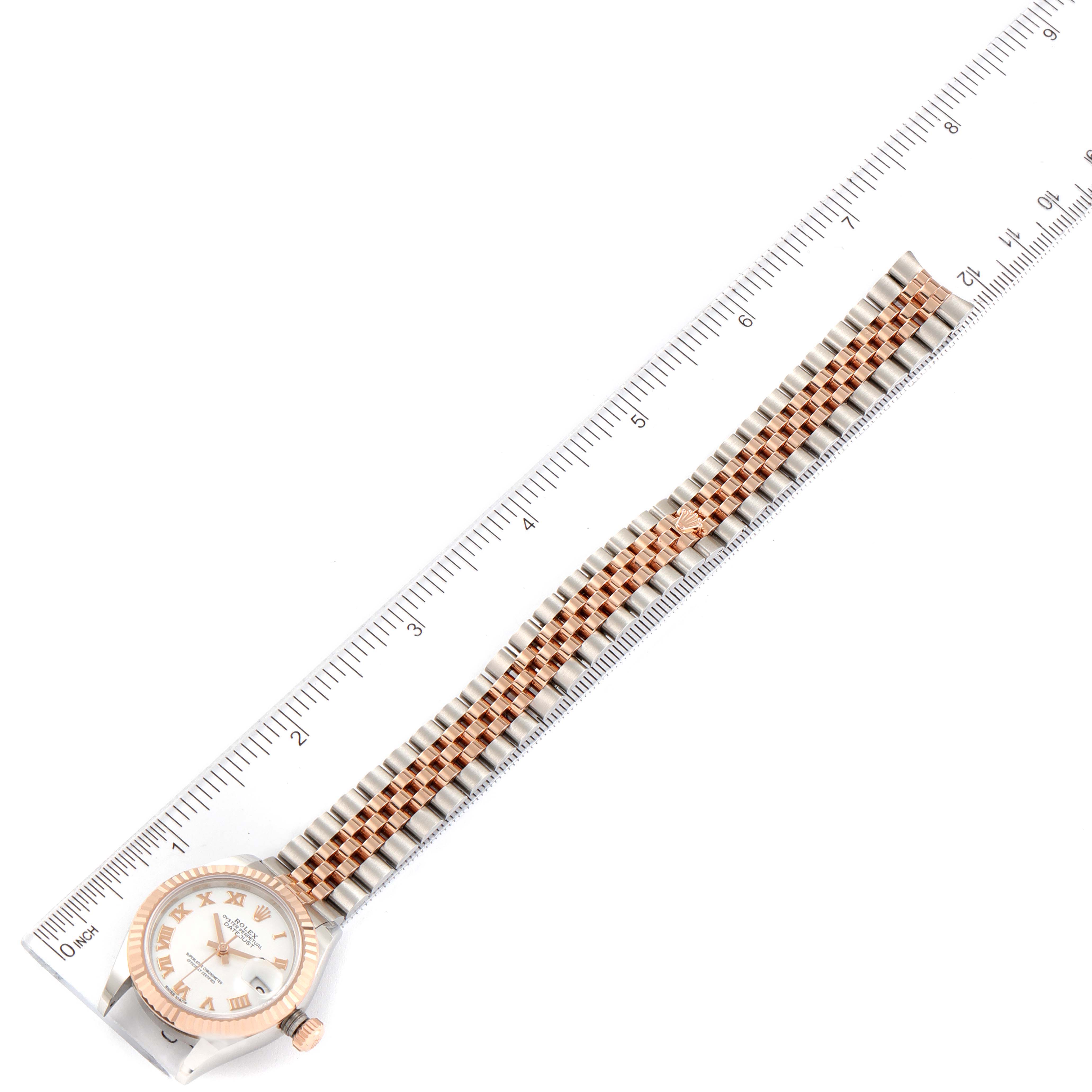 The Rolex Datejust 279171 Women
s Stainless Steel White Dial 279171 Women
s Stainless Steel White Dial watch is shown from a top-down angle, displaying its face, bracelet, and a ruler for scale.