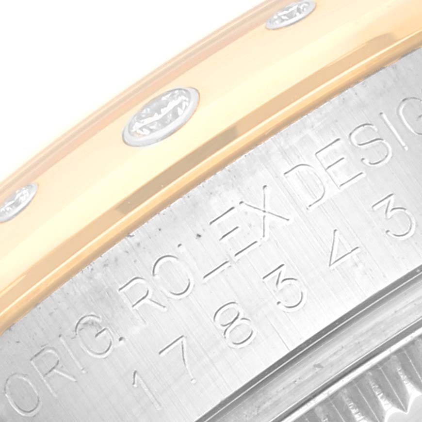 The image shows a close-up of the side engraving and bezel with diamonds of a Rolex Mid-Size 178343 Women
s Steel and Gold (two tone) Mother of Pearl Dial 178343 Women
s Steel and Gold (two tone) Mother of Pearl Dial model watch.