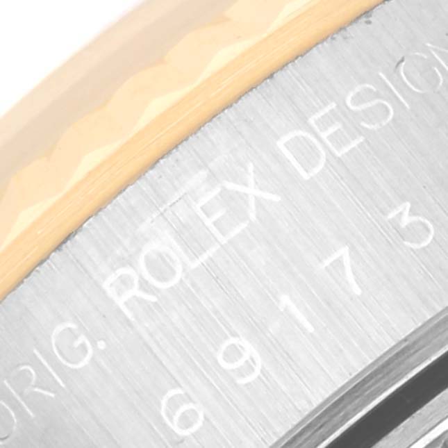 The image shows a close-up of the engraved bezel and side of a Rolex Datejust 69173 Women's Steel and Gold (two tone) Blue Dial 69173 Women's Steel and Gold (two tone) Blue Dial watch.