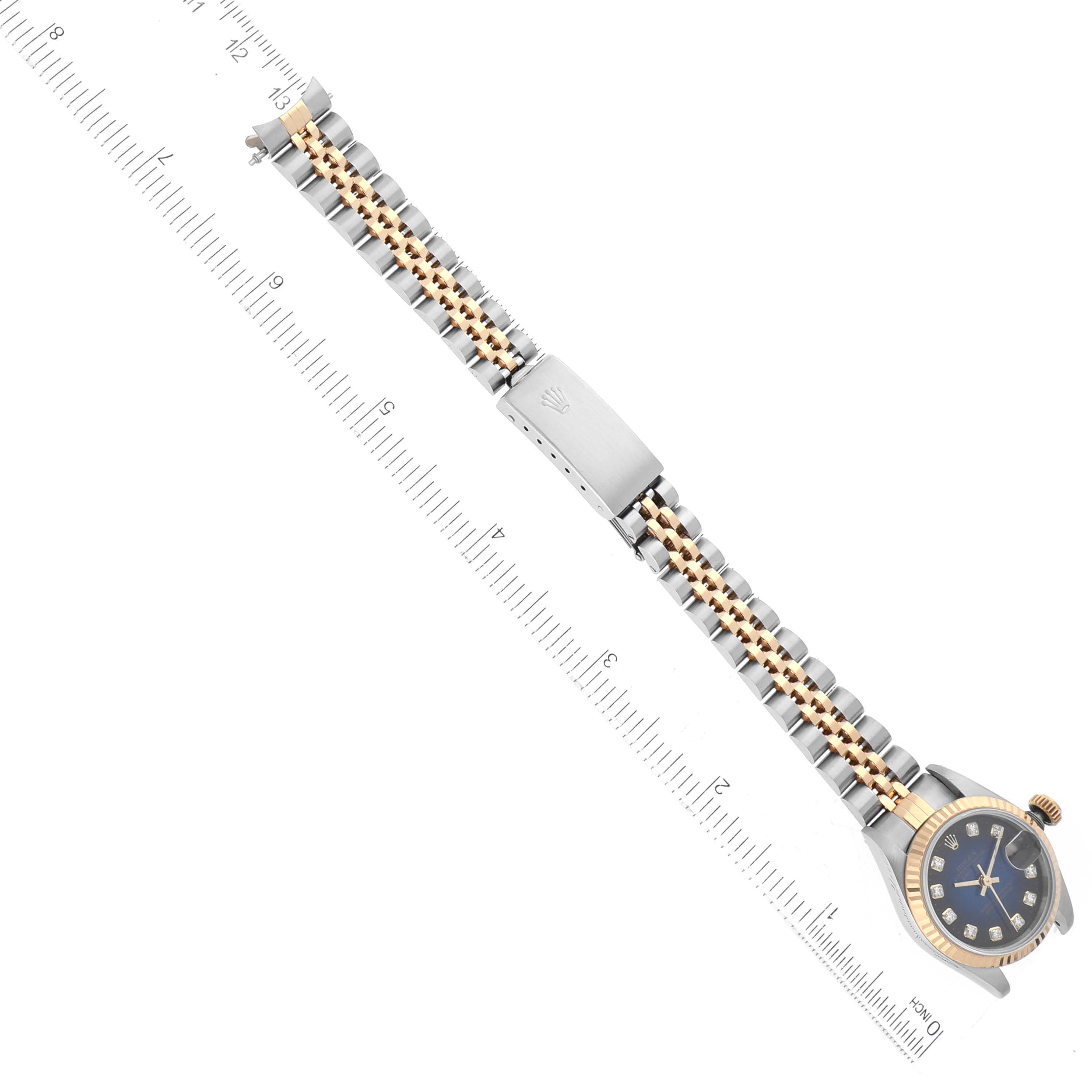 The image shows a top-down view of a Rolex Datejust 69173 Women's Steel and Gold (two tone) Blue Dial 69173 Women's Steel and Gold (two tone) Blue Dial watch featuring its face, band, and clasp with a ruler for scale.