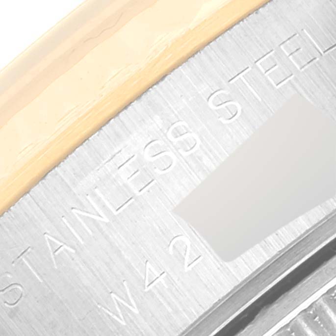 This image shows a close-up of the stainless steel and gold bezel of a Rolex Datejust 69173 Women's Steel and Gold (two tone) Blue Dial 69173 Women's Steel and Gold (two tone) Blue Dial watch.