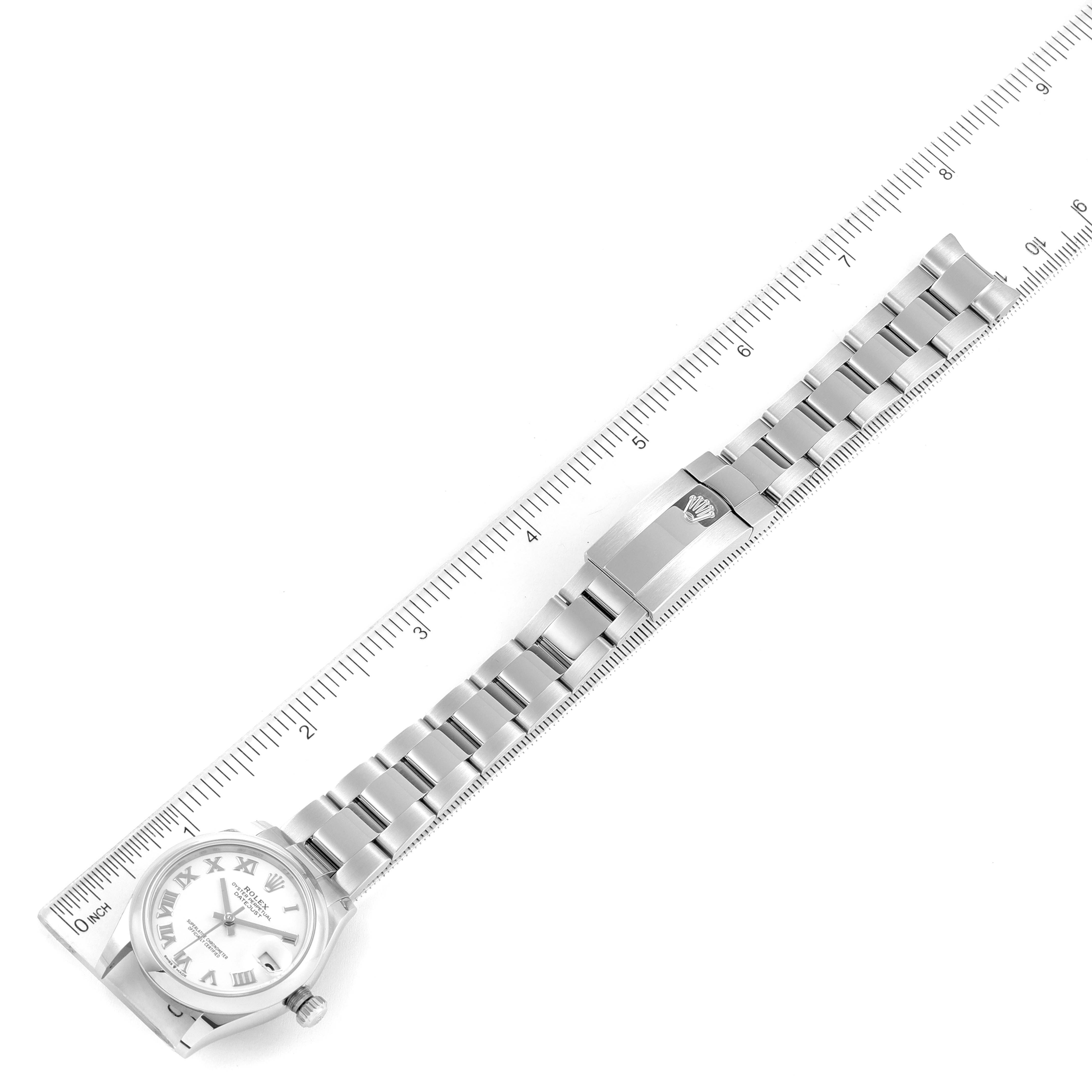 The Rolex Mid-Size 278240 Women
s Stainless Steel White Dial 278240 Women
s Stainless Steel White Dial watch is shown from a top-down angle, highlighting the face, bracelet, and clasp, against a ruler backdrop.
