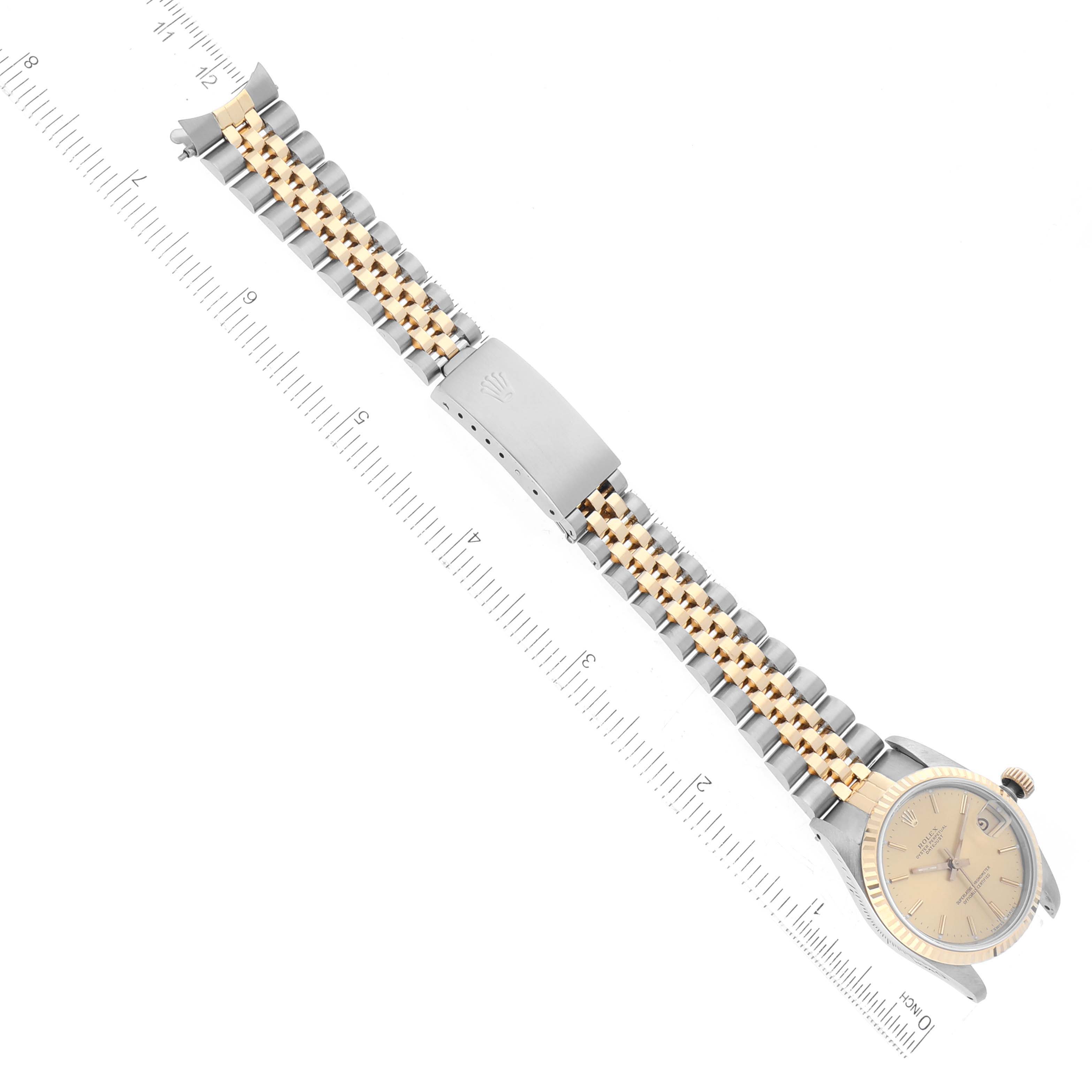 The image shows a top-down view of a Rolex Mid-Size 68273 Women's Steel and Gold (two tone) Champagne Dial 68273 Women's Steel and Gold (two tone) Champagne Dial watch with its dial, bezel, and two-tone bracelet.
