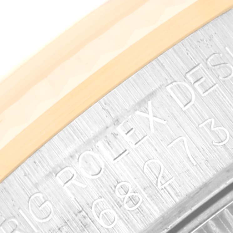 This image shows a close-up of the bezel and engraved text on the side of a Mid-Size Rolex watch.
