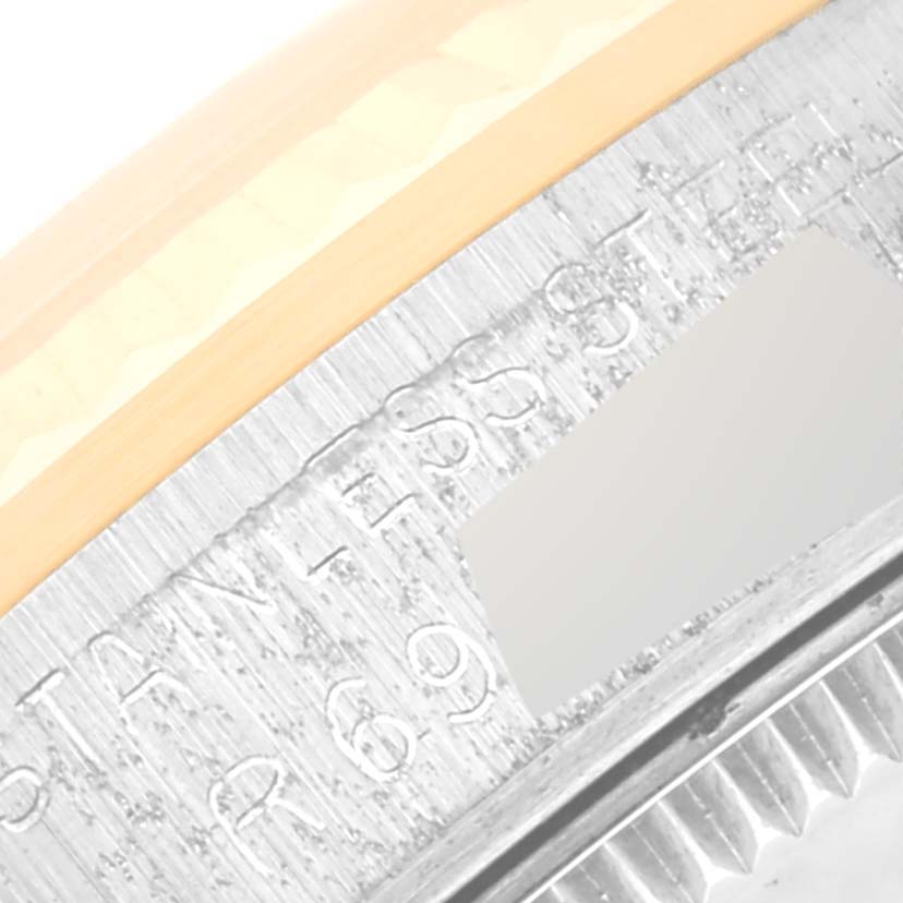 This close-up image shows the engraving on the caseback rim of a Mid-Size Rolex watch.