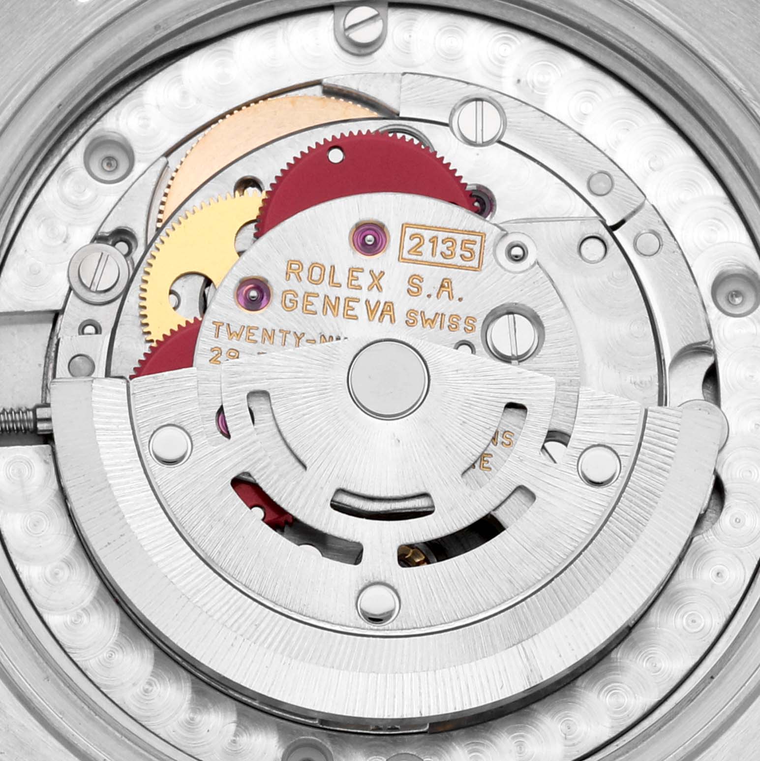 Close-up of the internal mechanism of a mid-size Rolex watch, showcasing gears and inscriptions.