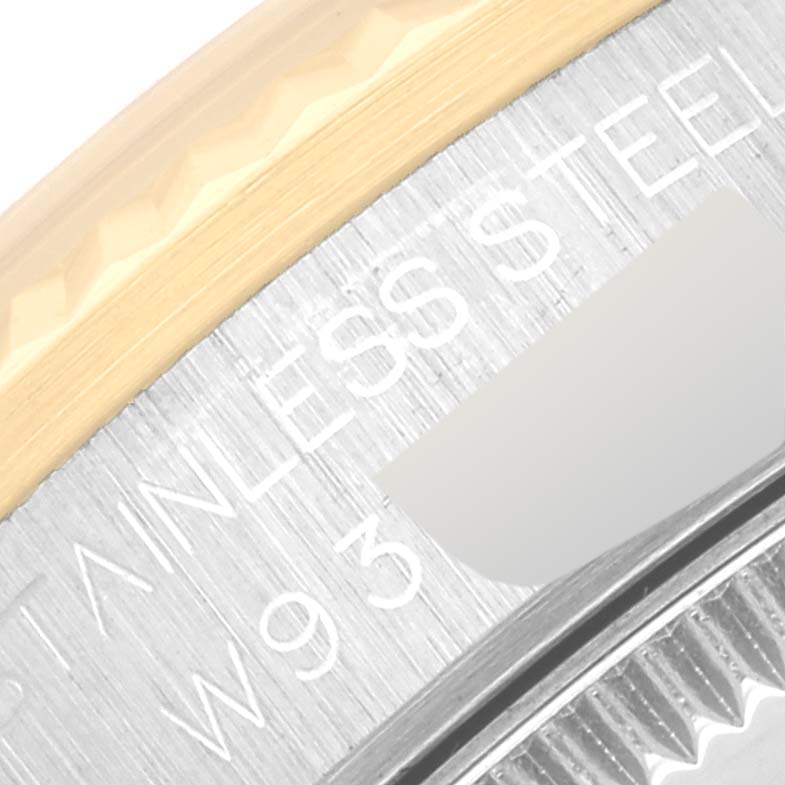 This close-up image shows the side of the Rolex Mid-Size 68273G Women's Steel and Gold (two tone) Blue Dial 68273G Women's Steel and Gold (two tone) Blue Dial model watch, highlighting the "STAINLESS STEEL" text and part of the bezel.