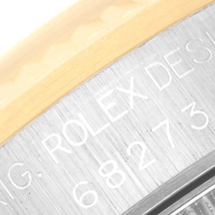 The image shows a close-up of the case side of the Rolex Mid-Size 68273G Women's Steel and Gold (two tone) Blue Dial 68273G Women's Steel and Gold (two tone) Blue Dial model, highlighting the engraving on the bezel.