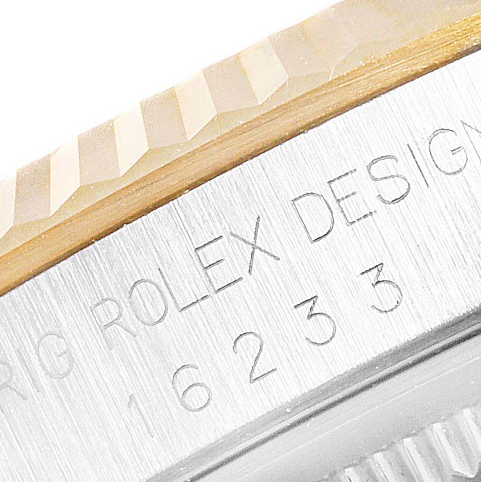 This close-up image of a Rolex Datejust 16233 Men's Steel and Gold (two tone) Black Dial 16233 Men's Steel and Gold (two tone) Black Dial watch shows part of the bezel and the engraved model number.