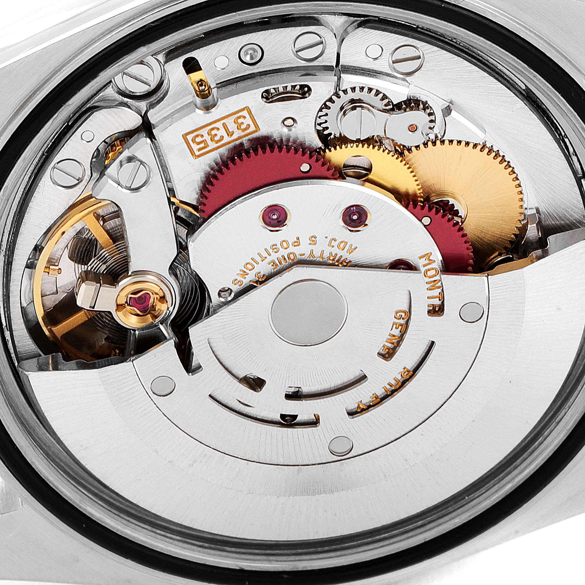 This is an internal view of the movement mechanism of a Rolex Datejust 16233 Men's Steel and Gold (two tone) Black Dial 16233 Men's Steel and Gold (two tone) Black Dial watch, showcasing the gears and intricate components.