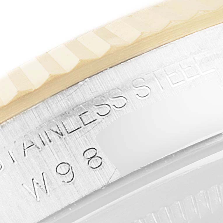 Close-up of the bezel and case side inscription of a Rolex Datejust 16233 Men's Steel and Gold (two tone) Black Dial 16233 Men's Steel and Gold (two tone) Black Dial watch, showing "STAINLESS STEEL" and part of a serial number.