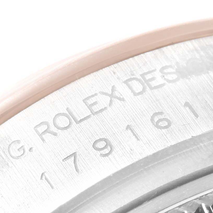 The image shows a close-up of the serial number and "Rolex Design" engraving on the case of a Rolex Datejust 179161 Women's Rose Gold Pink Dial 179161 Women's Rose Gold Pink Dial watch.