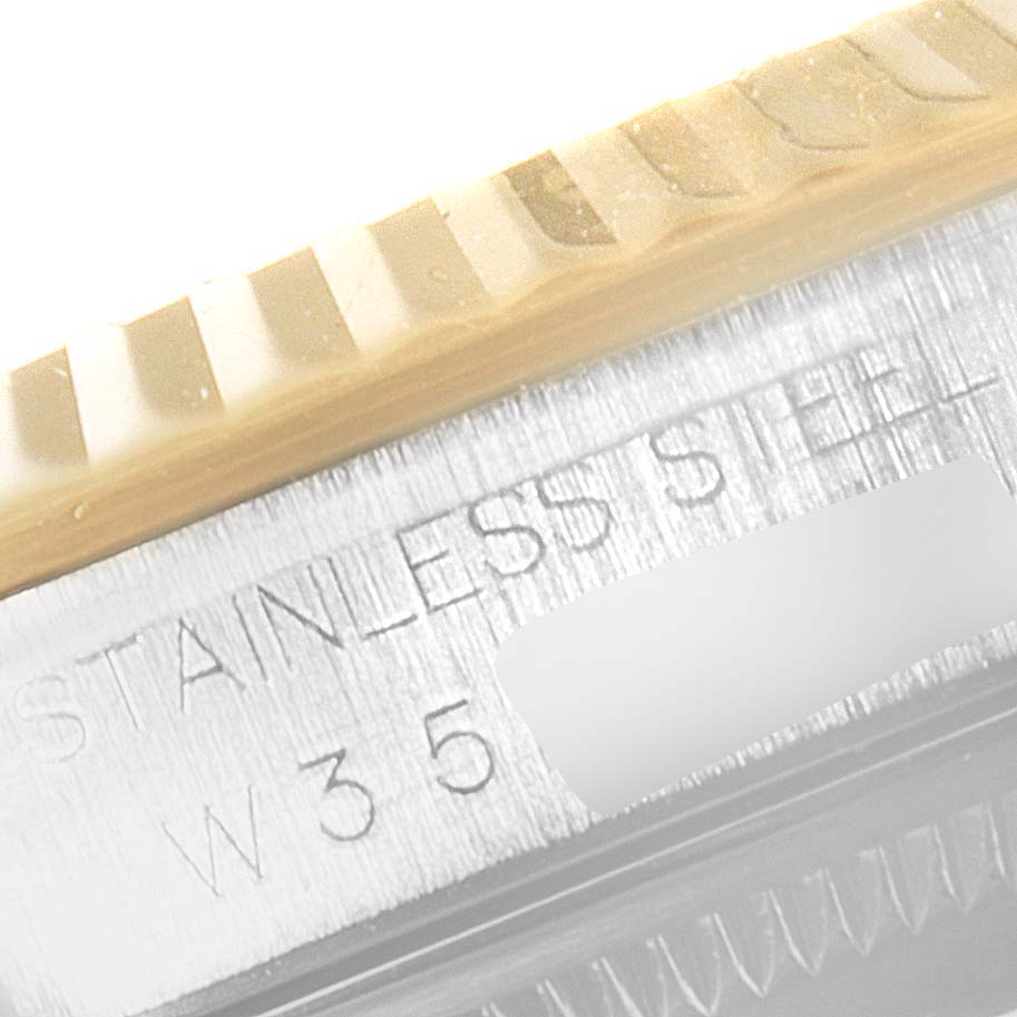 This close-up image shows the fluted bezel and engraved details of the stainless steel casing of a Rolex Datejust 16233 Men's Steel and Gold (two tone) Champagne Dial 16233 Men's Steel and Gold (two tone) Champagne Dial watch.