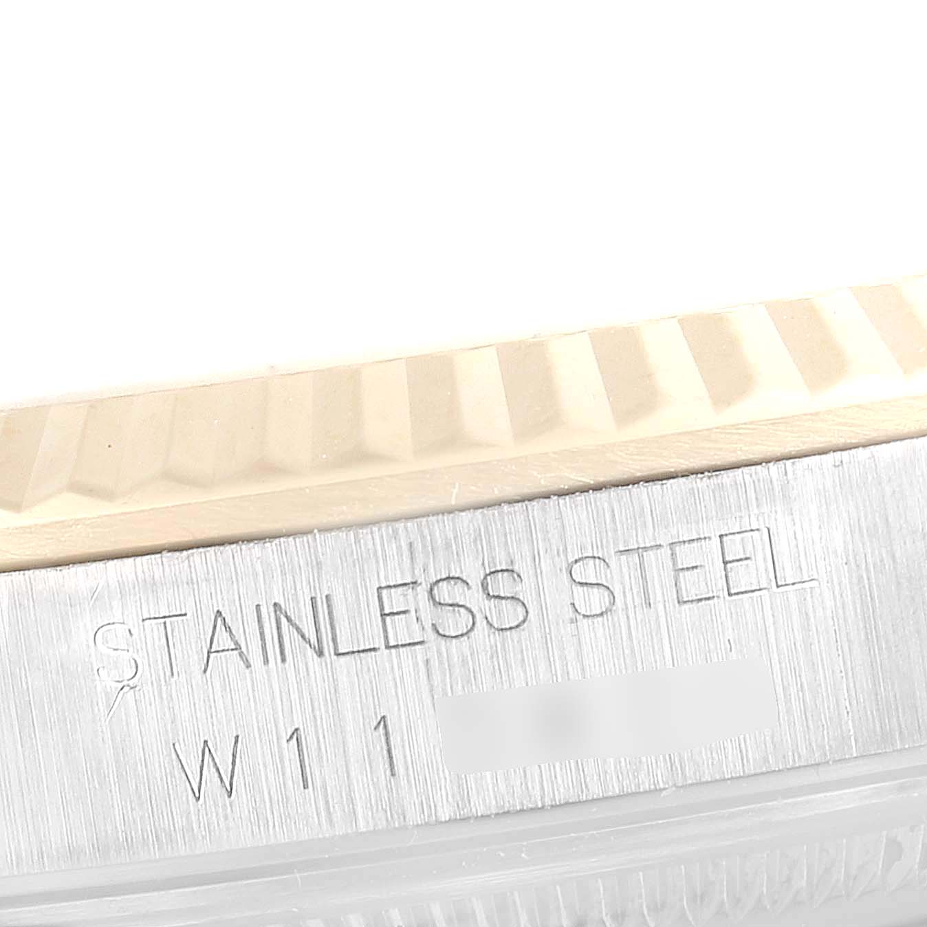 This image shows a close-up of the stainless steel side of a Rolex Datejust 16233 Men's Steel and Gold (two tone) Champagne Dial 16233 Men's Steel and Gold (two tone) Champagne Dial watch, highlighting the edge of the fluted bezel.