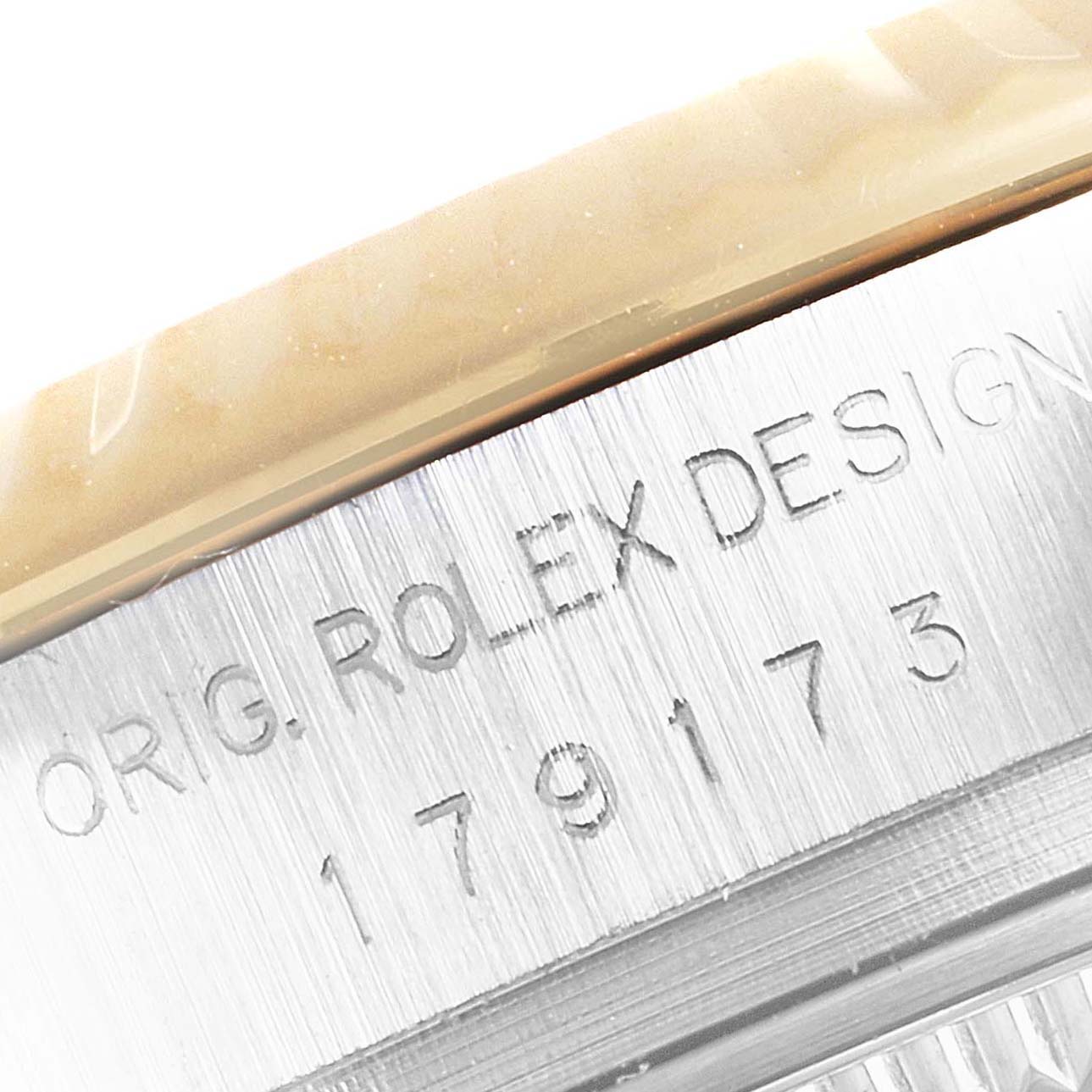 The image shows a close-up of the case side of a Rolex Datejust 179173 Women's Steel and Gold (two tone) Mother of Pearl Dial 179173 Women's Steel and Gold (two tone) Mother of Pearl Dial watch, displaying the engraved model number and "ORIG. ROLEX DESIGN".