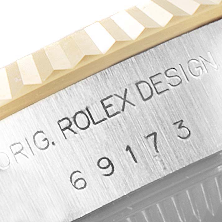 This close-up image shows the bezel and serial number engraving of a Rolex Datejust 69173 Women's Steel and Gold (two tone) Grey Dial 69173 Women's Steel and Gold (two tone) Grey Dial watch.