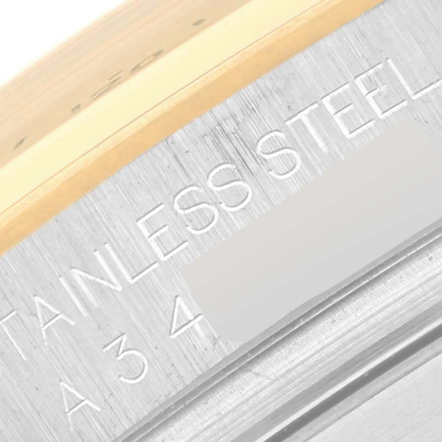 This close-up shows the edge of the back case of a Rolex Daytona 16523 Men's Steel and Gold (two tone) Champagne Dial 16523 Men's Steel and Gold (two tone) Champagne Dial watch, highlighting the "Stainless Steel" engraving.