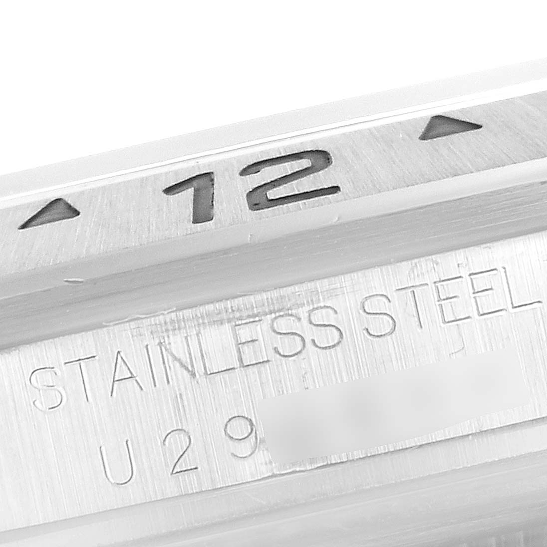 This close-up image shows the bezel and part of the case with the "stainless steel" engraving of a Rolex Explorer 16570 Men
s Stainless Steel Black Dial 16570 Men
s Stainless Steel Black Dial watch.