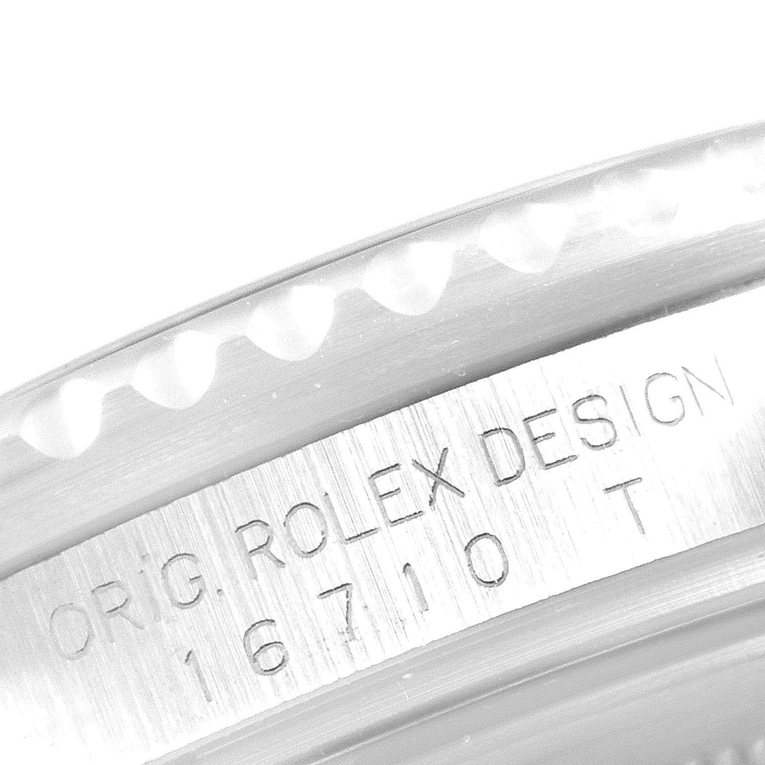 The image shows a close-up of the etched bezel and case side of a Rolex GMT-Master 16710 Men's Stainless Steel Black Dial 16710 Men's Stainless Steel Black Dial model, showcasing the reference number "16710 T."